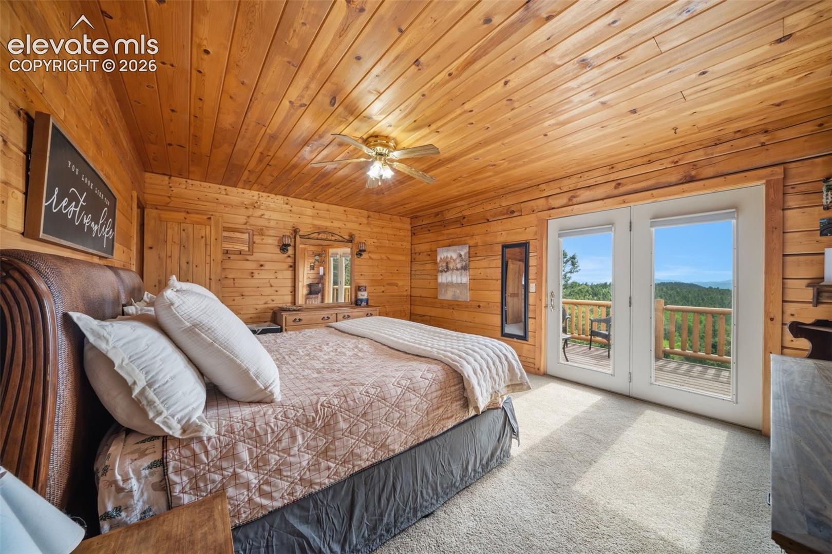 Main level primary bedroom with walk out to back deck and the view are stunning