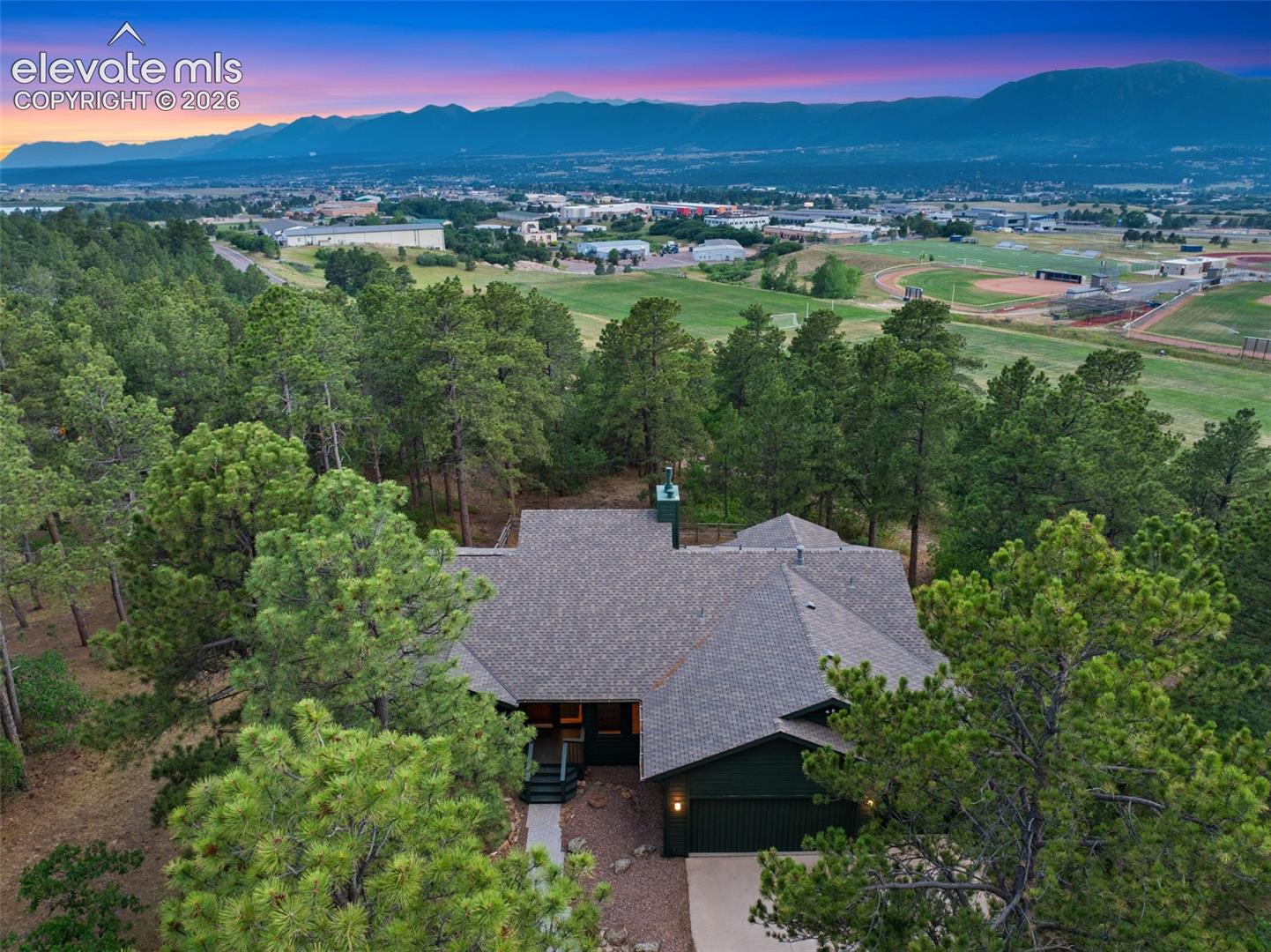 Single-story residence set amidst mature evergreen trees
