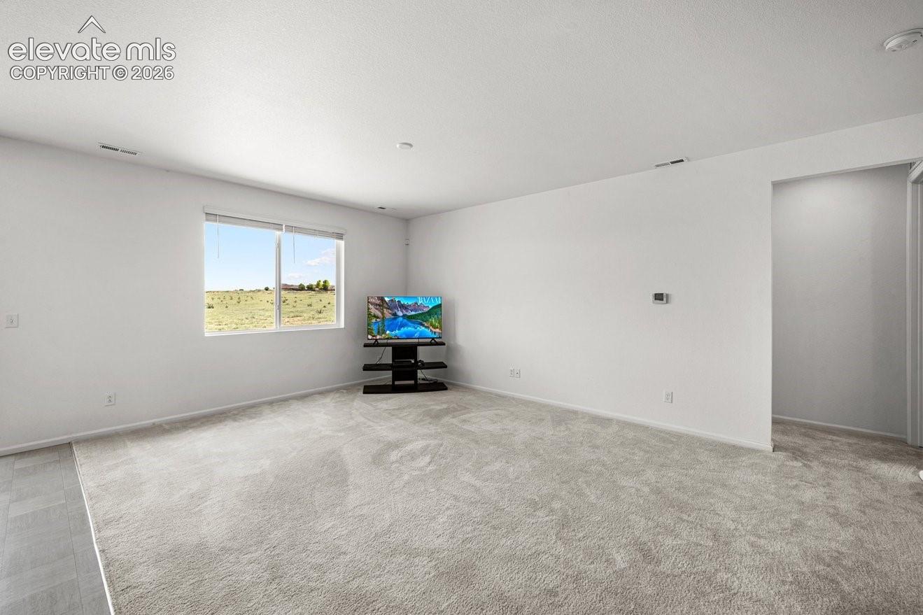 Bright interior featuring light-toned walls and plush carpeting