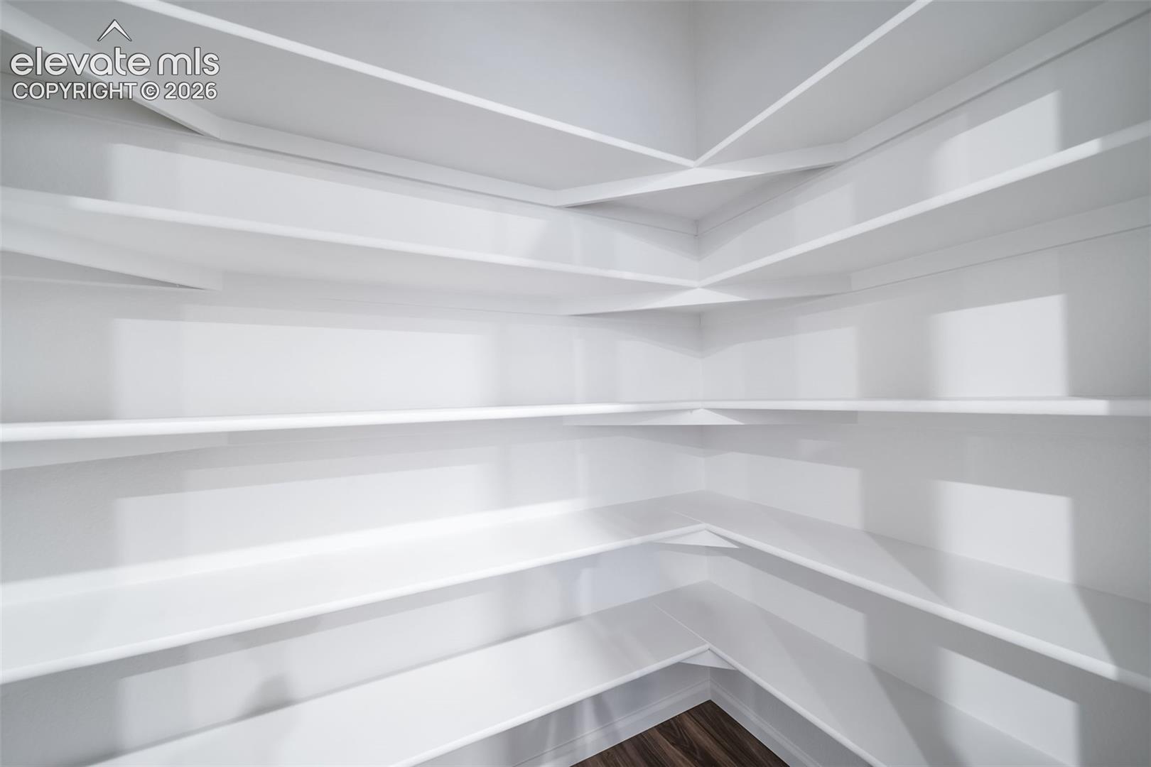Built-in shelving with white finishes and wood-finish flooring
*photos of a model home*