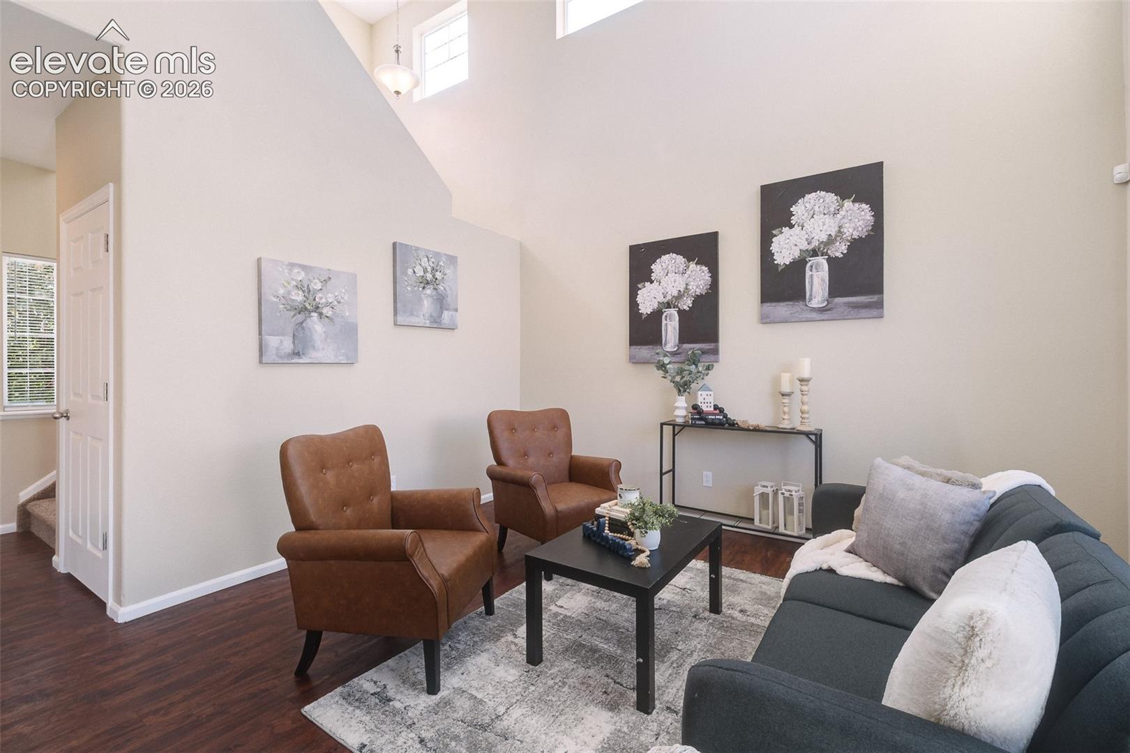 Vaulted ceilings, expansive wall space, high-placed windows, and wood-finish flooring