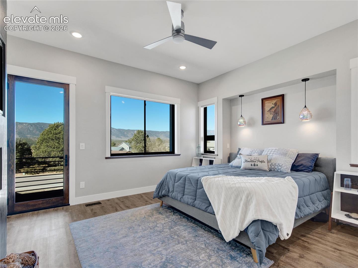 Primary bedroom with a modern ceiling fan and gas fireplace.