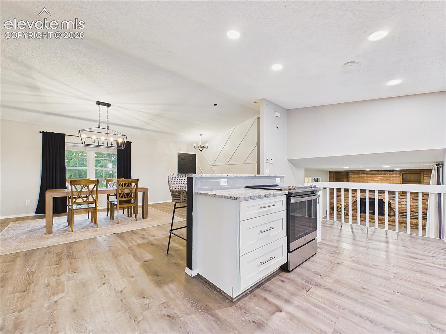 Open-concept kitchen overlooks the adjacent living spaces, enhancing connectivity and making entertaining effortless.
