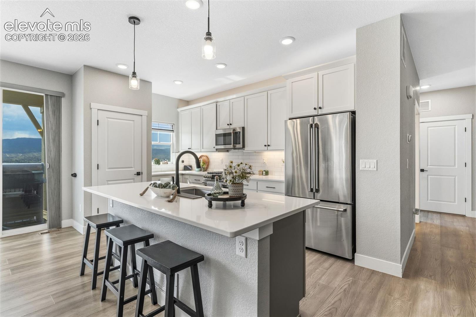 Hallway on the right leads to garage access, full bath and 2 bedrooms
