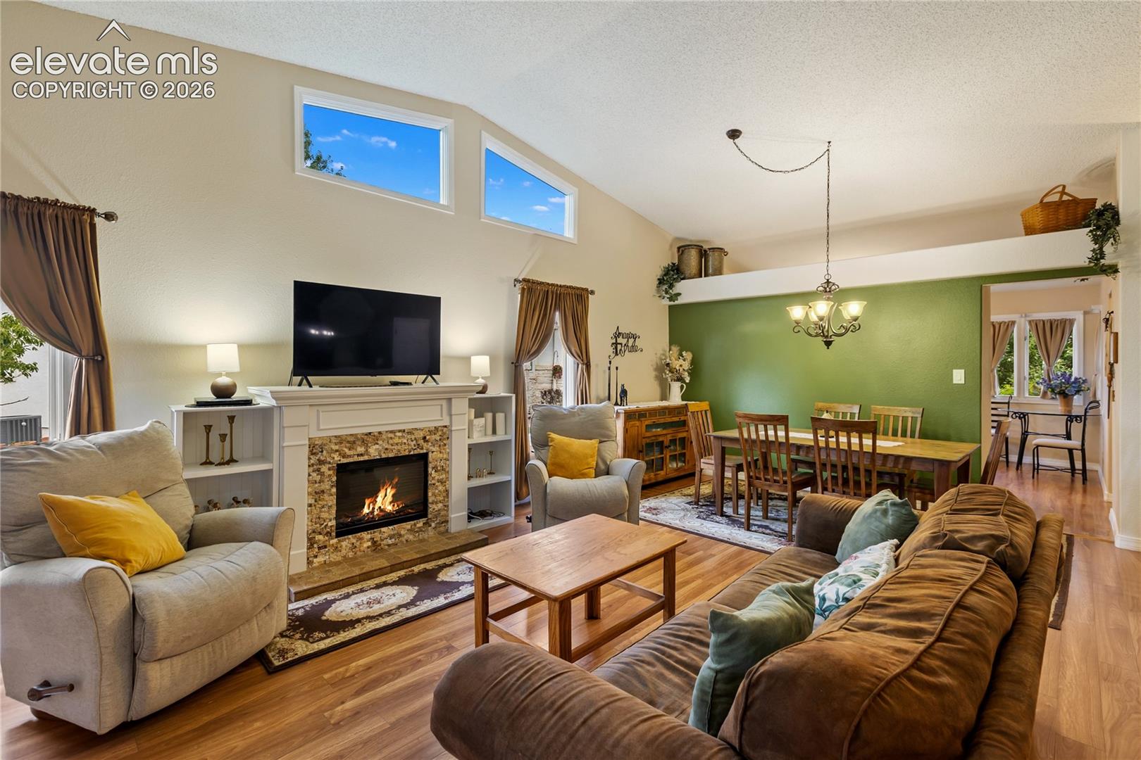 Living features vaulted ceilings, easy care laminate flooring. The fireplace is a separate piece of furniture but is negotiable! 