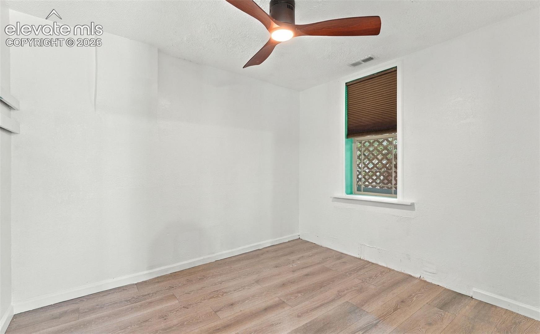 Ceiling fan with integrated lighting, window with blinds
