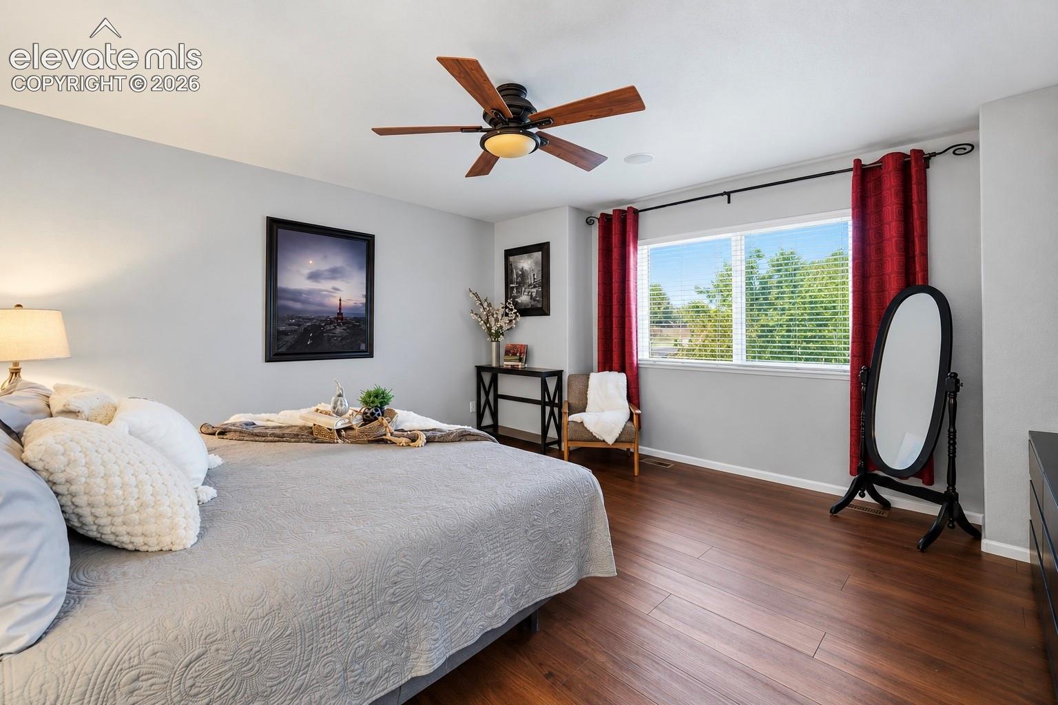 Natural light, warm flooring and ample room give the primary bedroom an easy, comfortable feel.