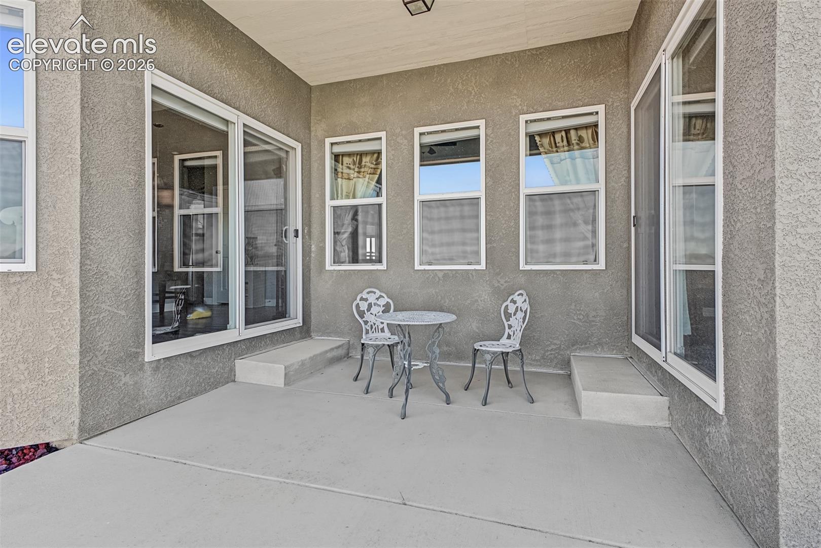 Enjoy dinner on the covered patio with easy access to the kitchen or primary bedroom.