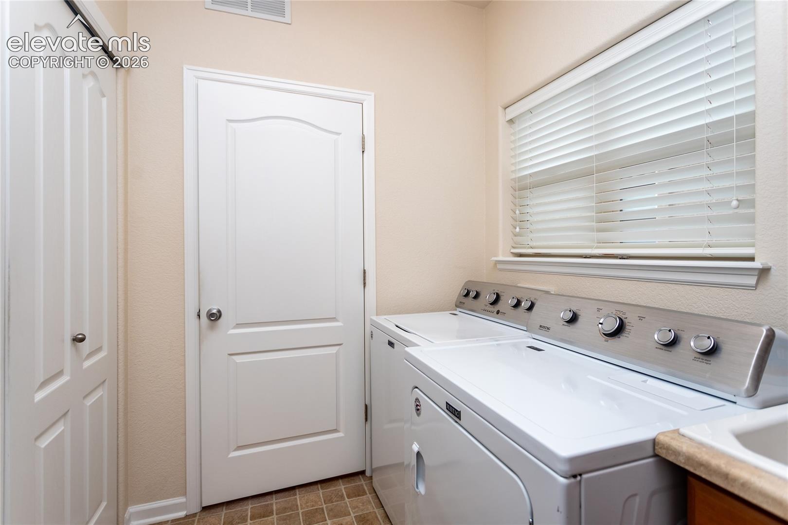 Spacious laundry room with sink.