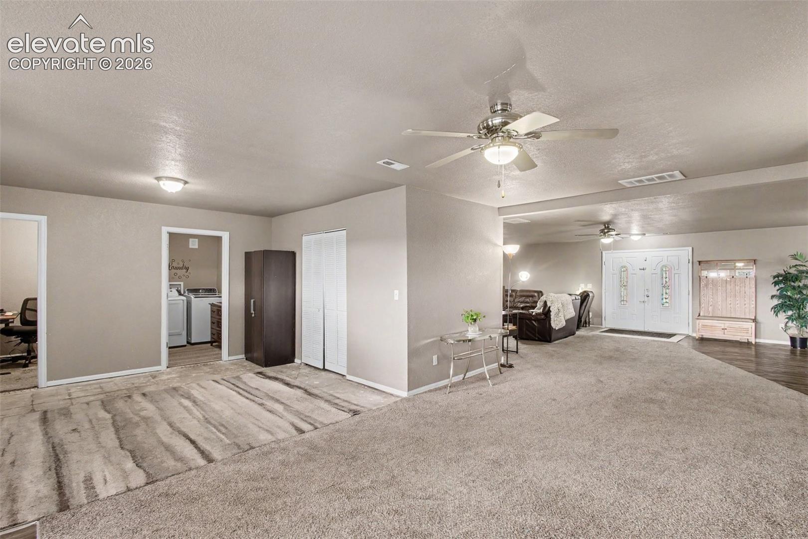 Airy family room seamlessly flowing into the dining area and conveniently connecting to the second living room, office, and laundry room. The versatile layout offers an ideal space for everyday living and entertaining.