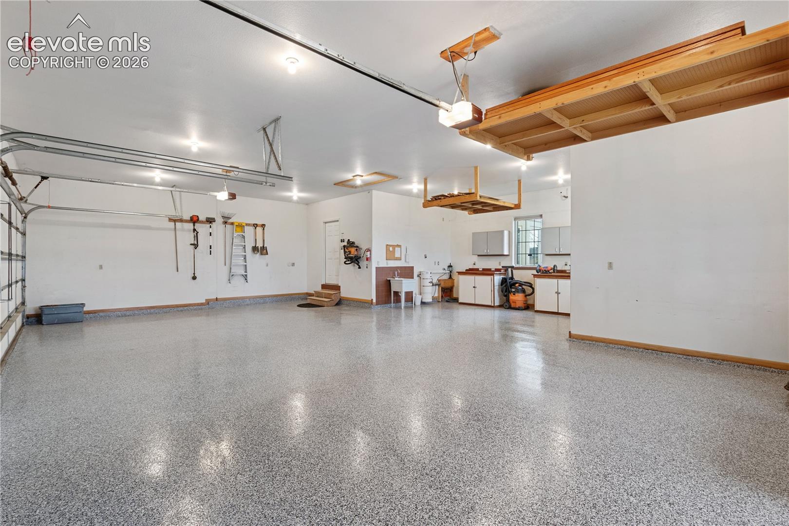 4 car garage with extra storage or work space, newly epoxied floors.