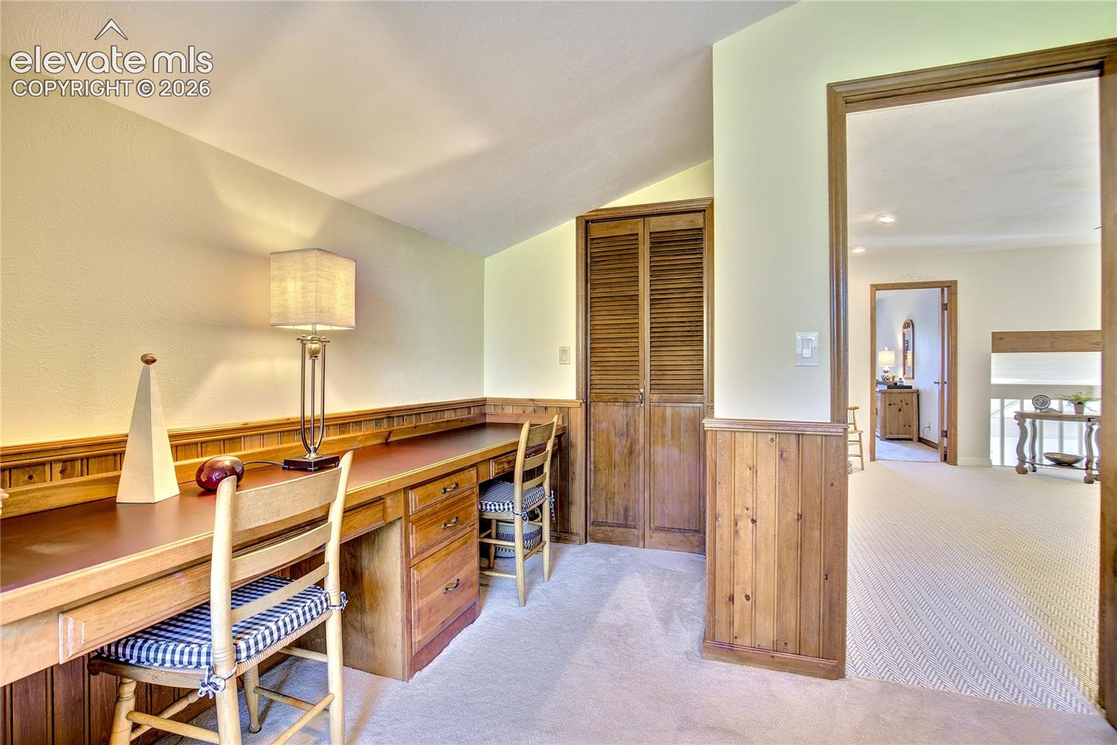 A built-in desk for two makes this spacious office exceptionally functional for working or studying from home.