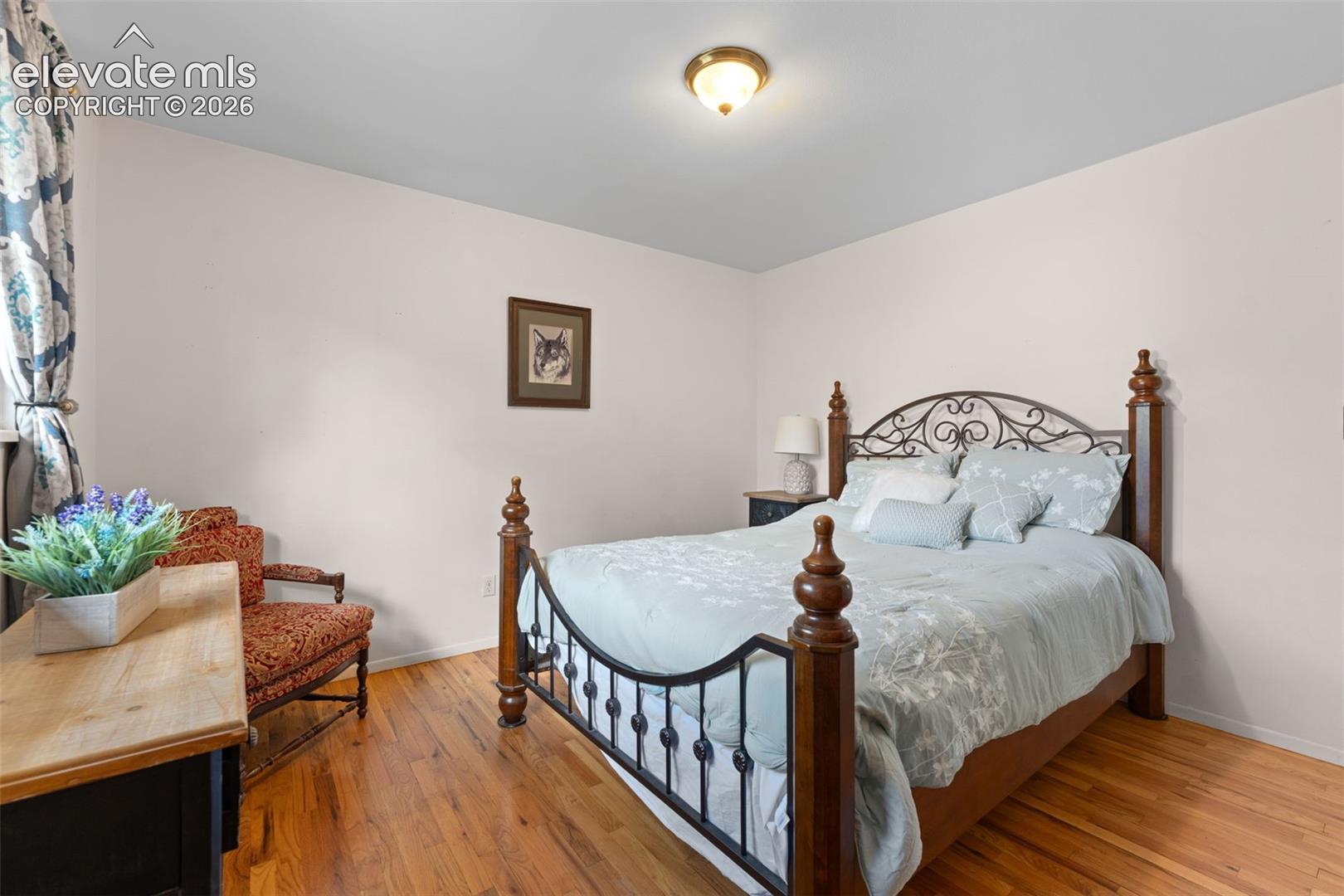 Hardwood flooring, neutral wall tones, semi-flush mount ceiling light