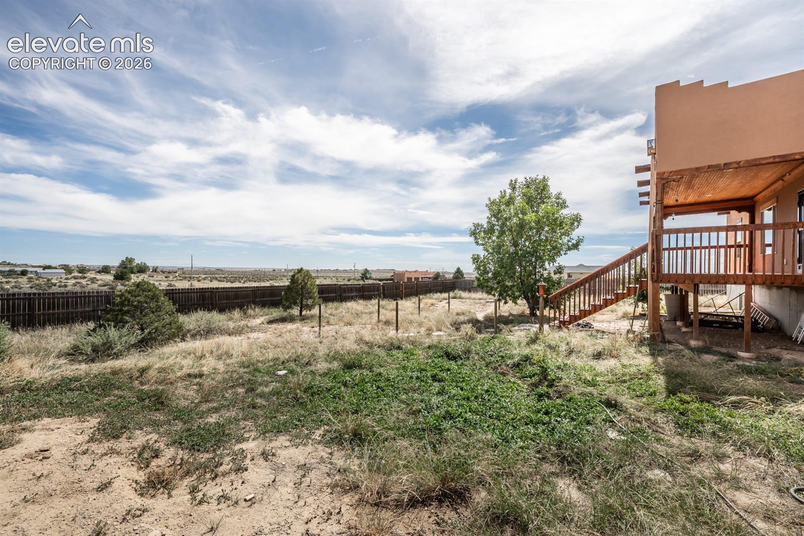 A view facing South rare to have a property in Pueblo West with some trees. A rare desert oasis.