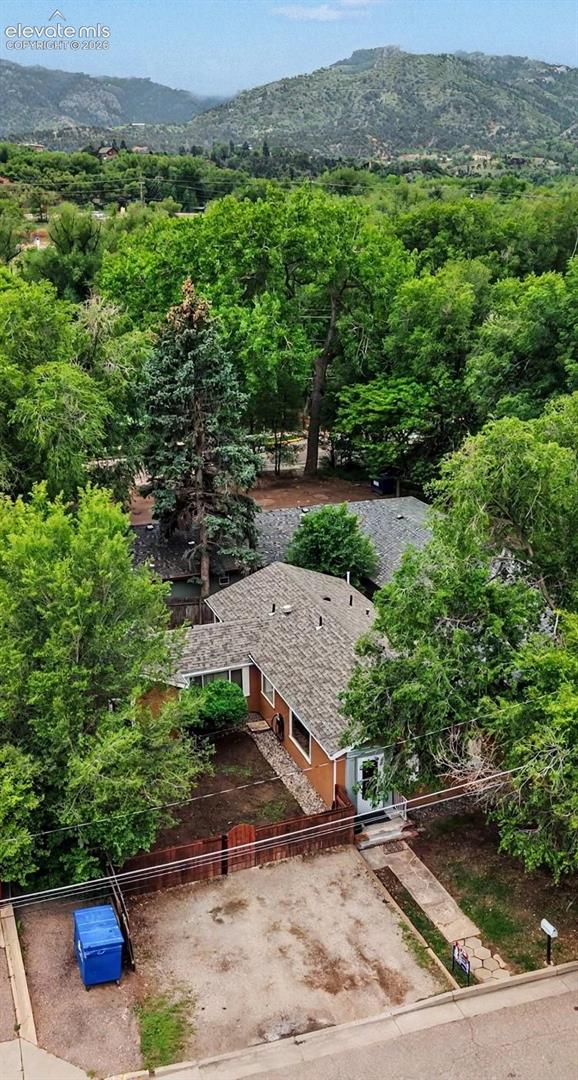 Tall trees surrounding house and neighborhood.