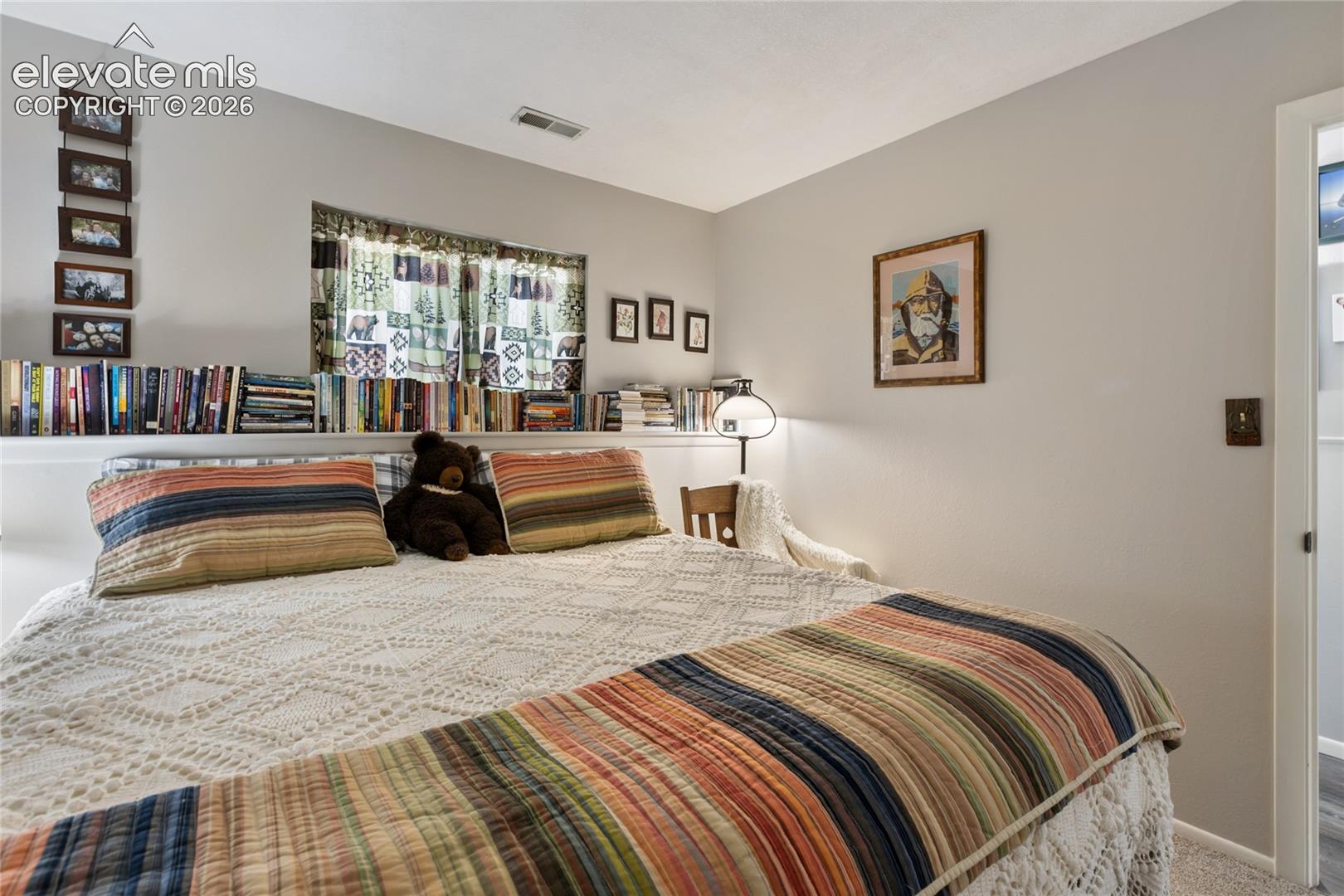 Integrated built-in shelving, window with natural light, and neutral wall color