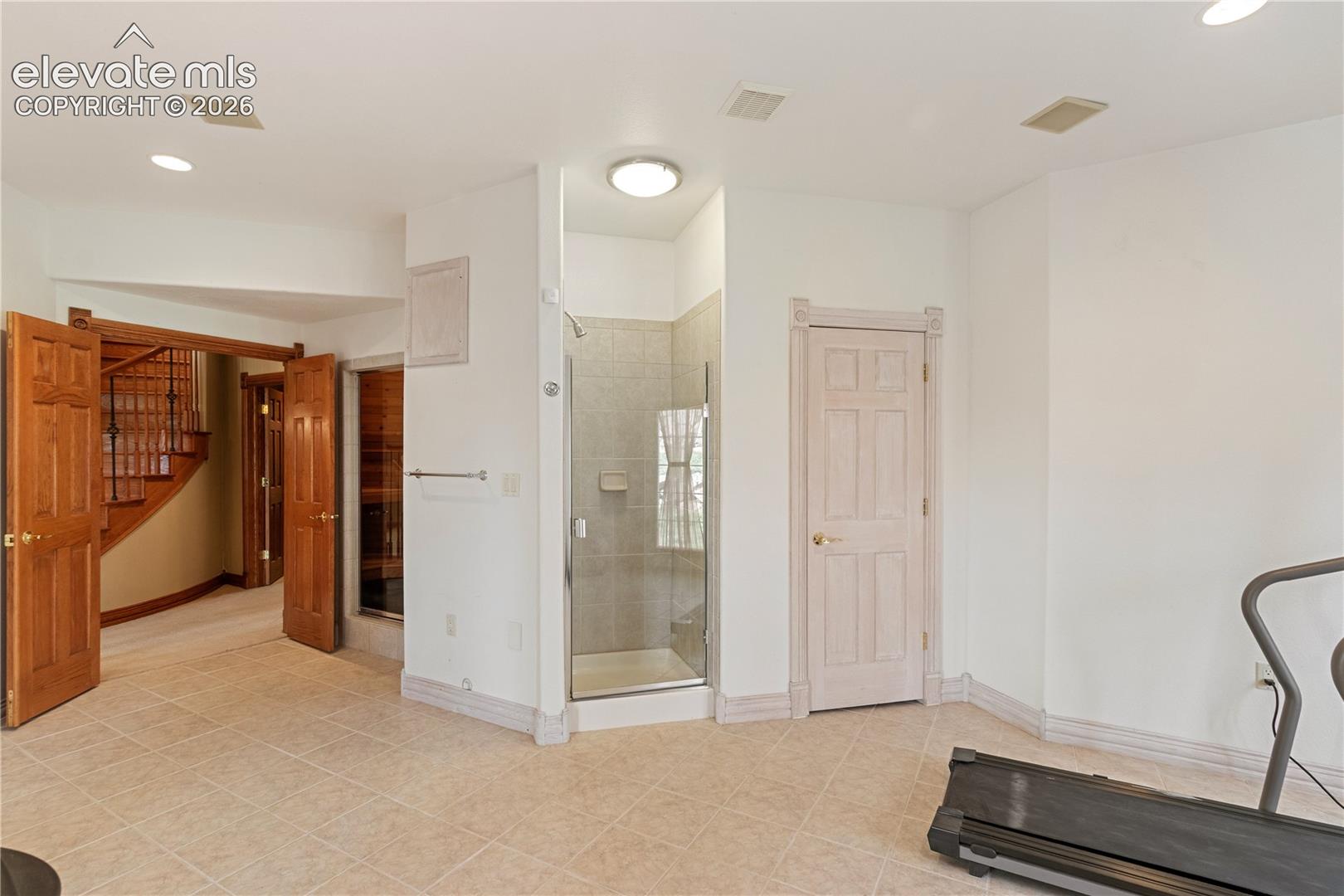 Workout room in basement with sauna and shower