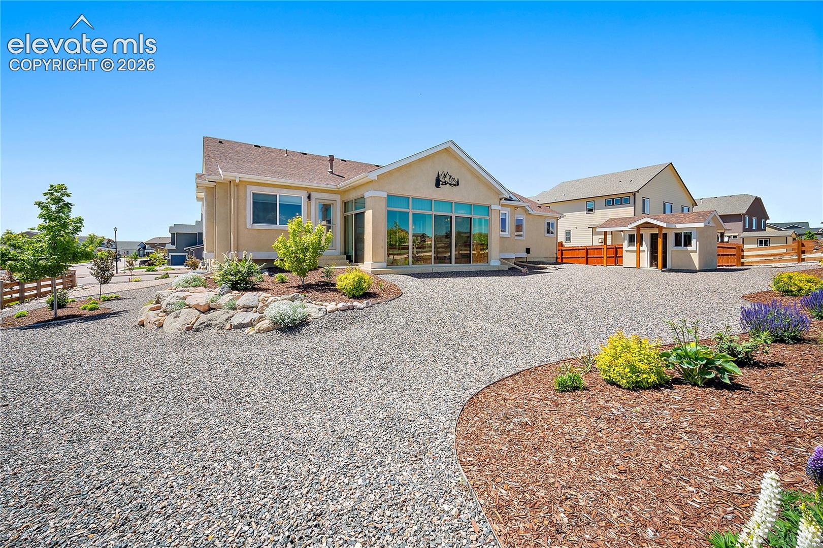 Back of the home, beautiful and well maintained landscaping. 