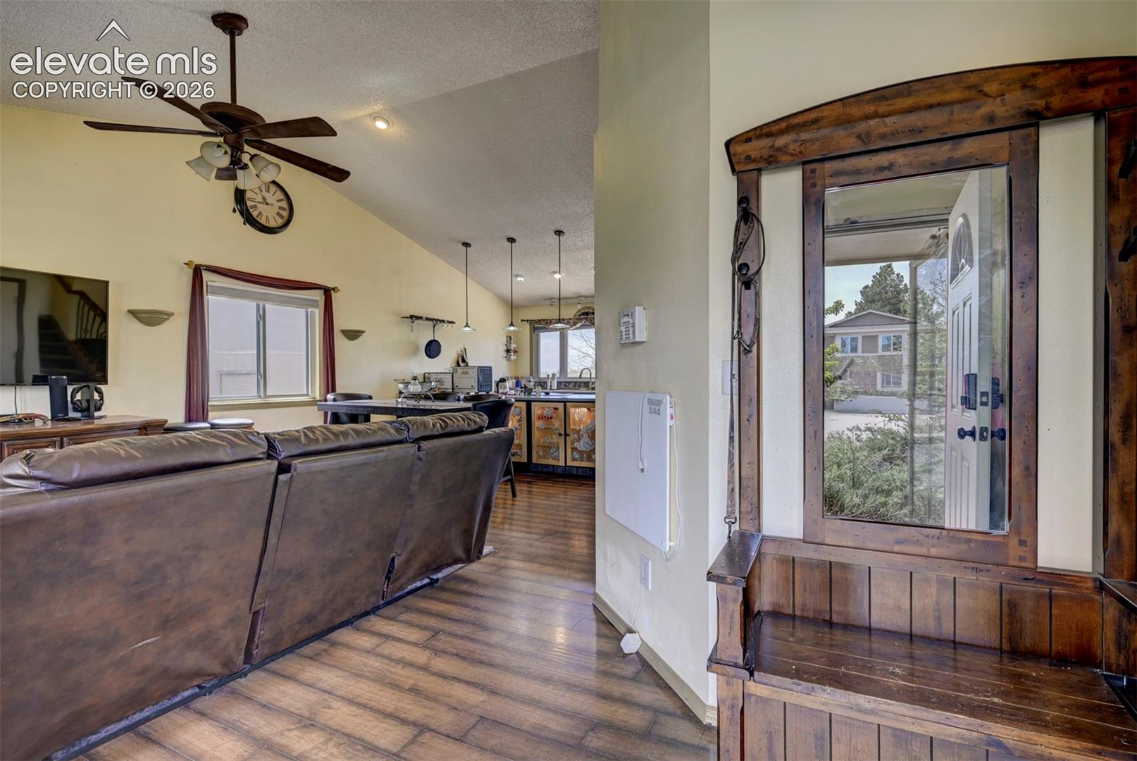 Entryway featuring a built-in wooden bench and framed mirror