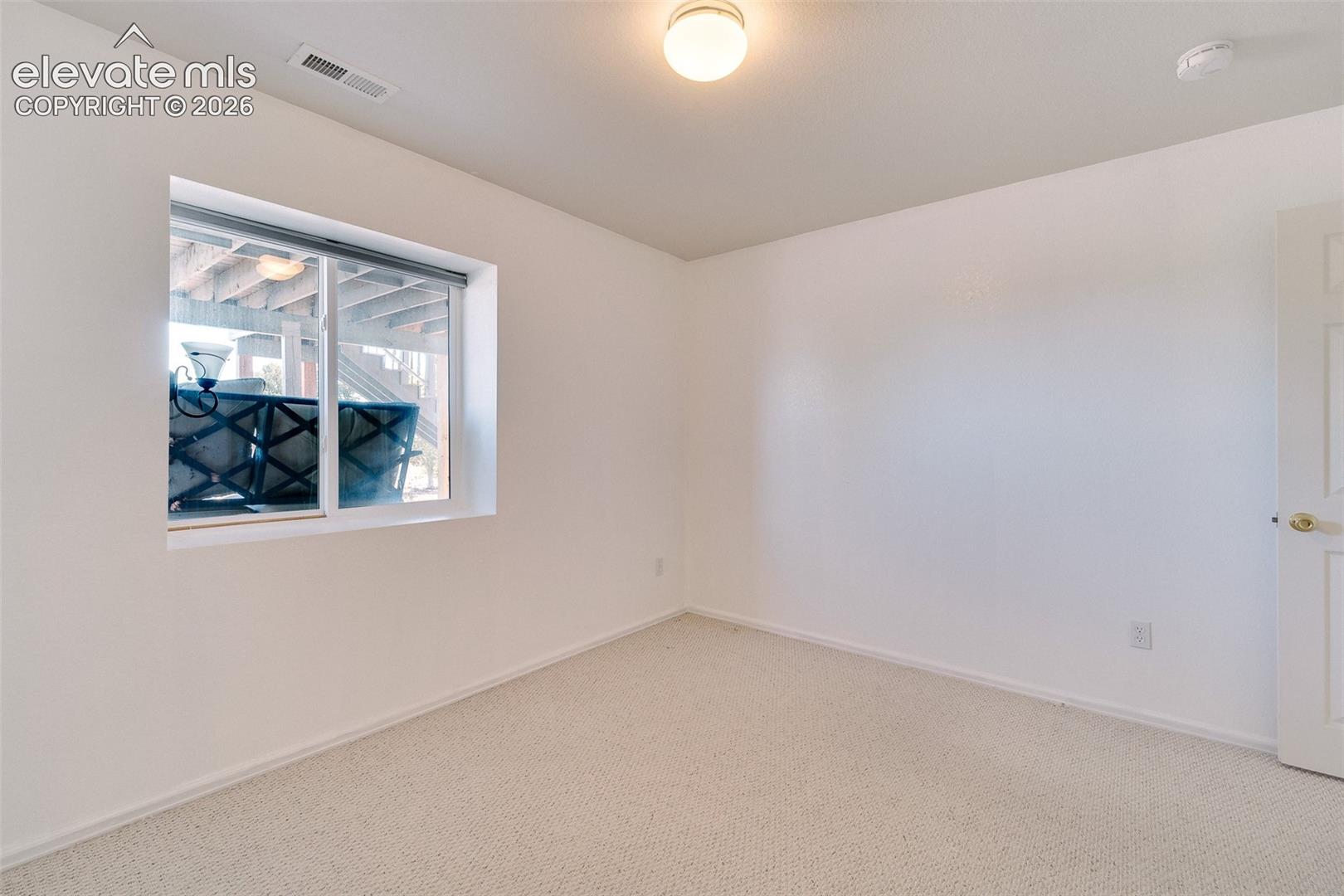 Basement Bedroom #4 has neutral carpet.