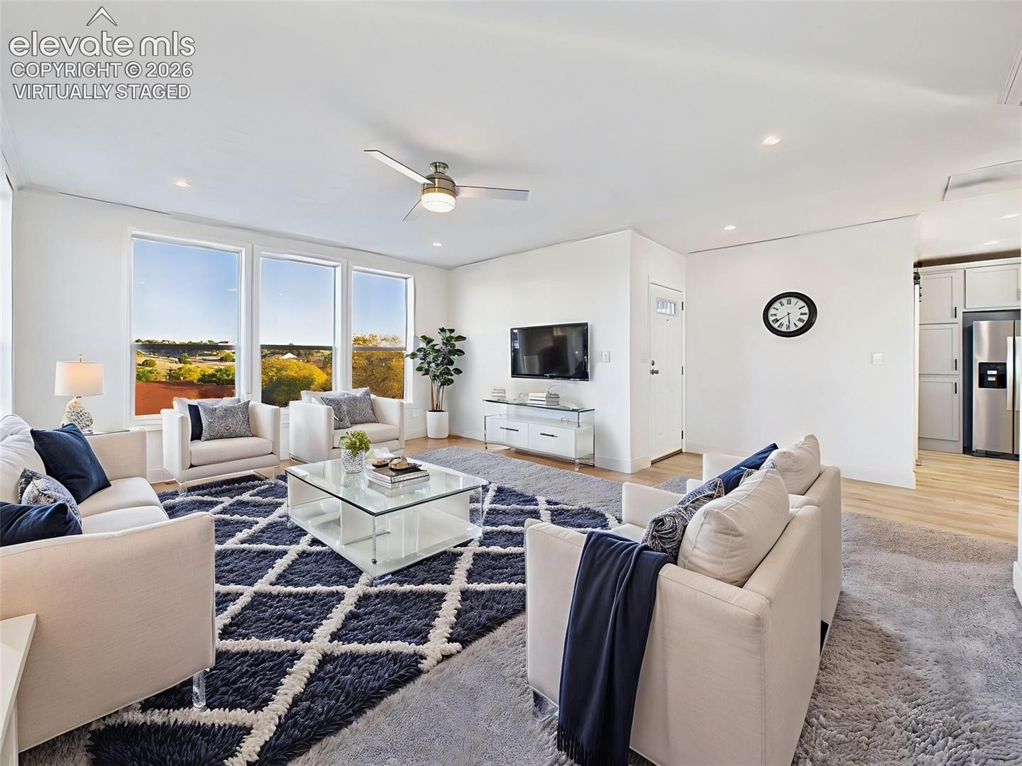 Virtually Staged the spacious great room—virtually staged to display furniture arrangement and natural sightlines.