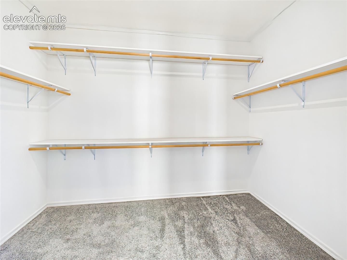 Generous walk-in closet with custom shelving and abundant storage.