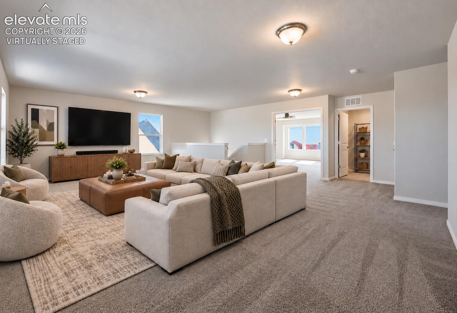 Virtually Staged loft Neutral wall color, wall-to-wall carpeting, multiple flush-mount ceiling light fixtures, and dual-pane windows