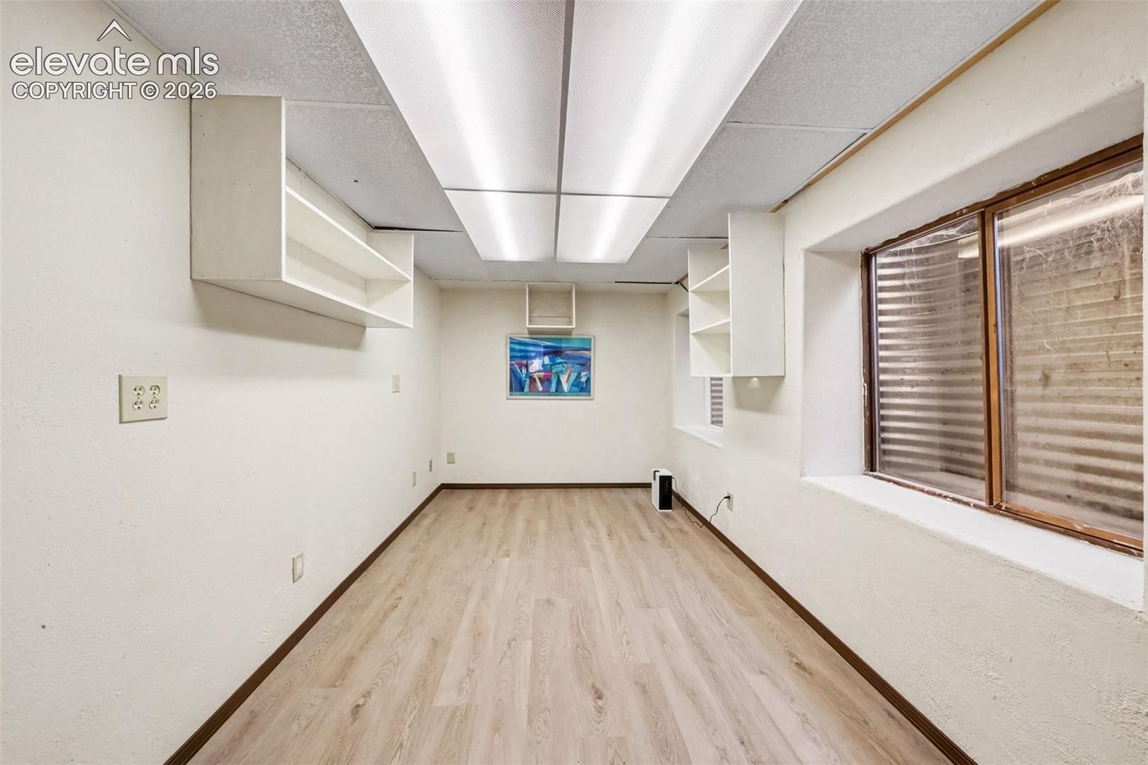 Bonus  basement room featuring LVT flooring and flexible space for guests, family, a home office, or a hobby room