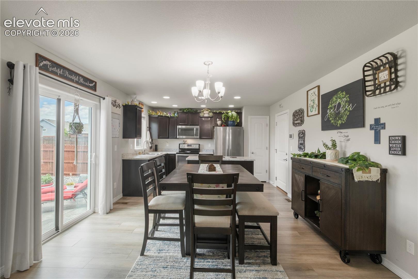 Kitchen featuring dark wood-finish cabinetry, stainless steel appliances, and light countertops