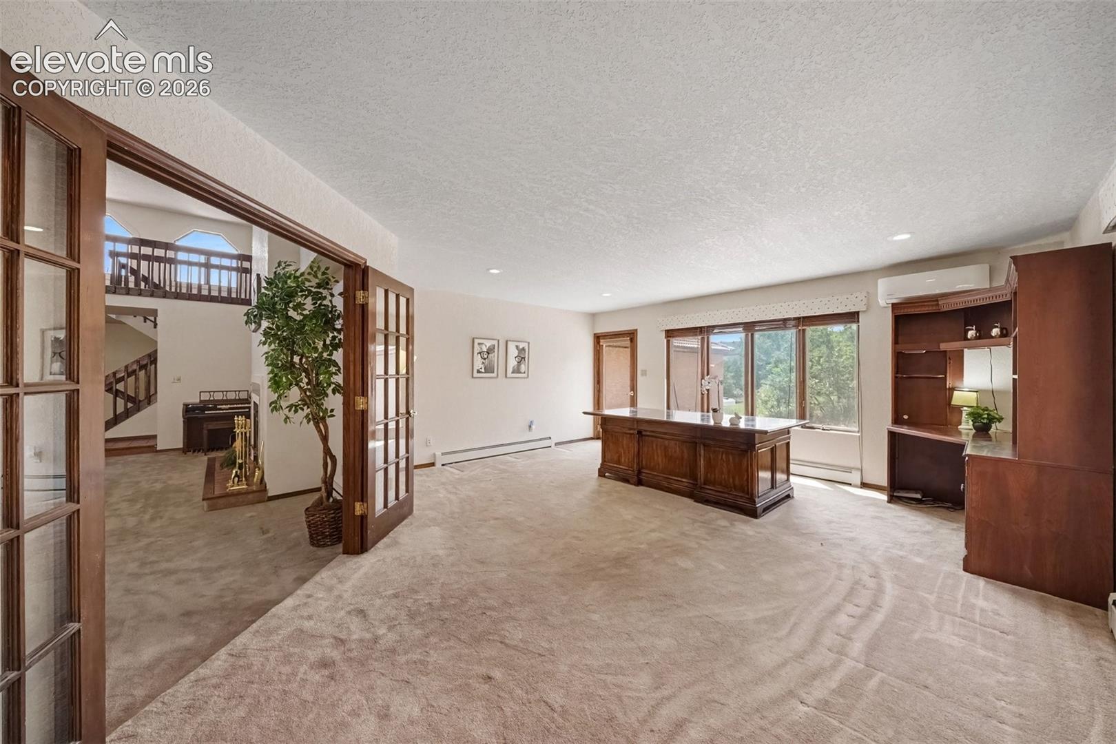 Main-level office features French doors, creating a quiet and versatile workspace with a convenient walkout to the outdoors