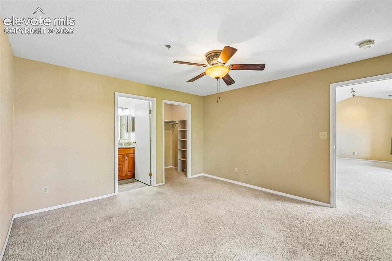 Primary bedroom with en suite 3/4 bathroom and walk in closet