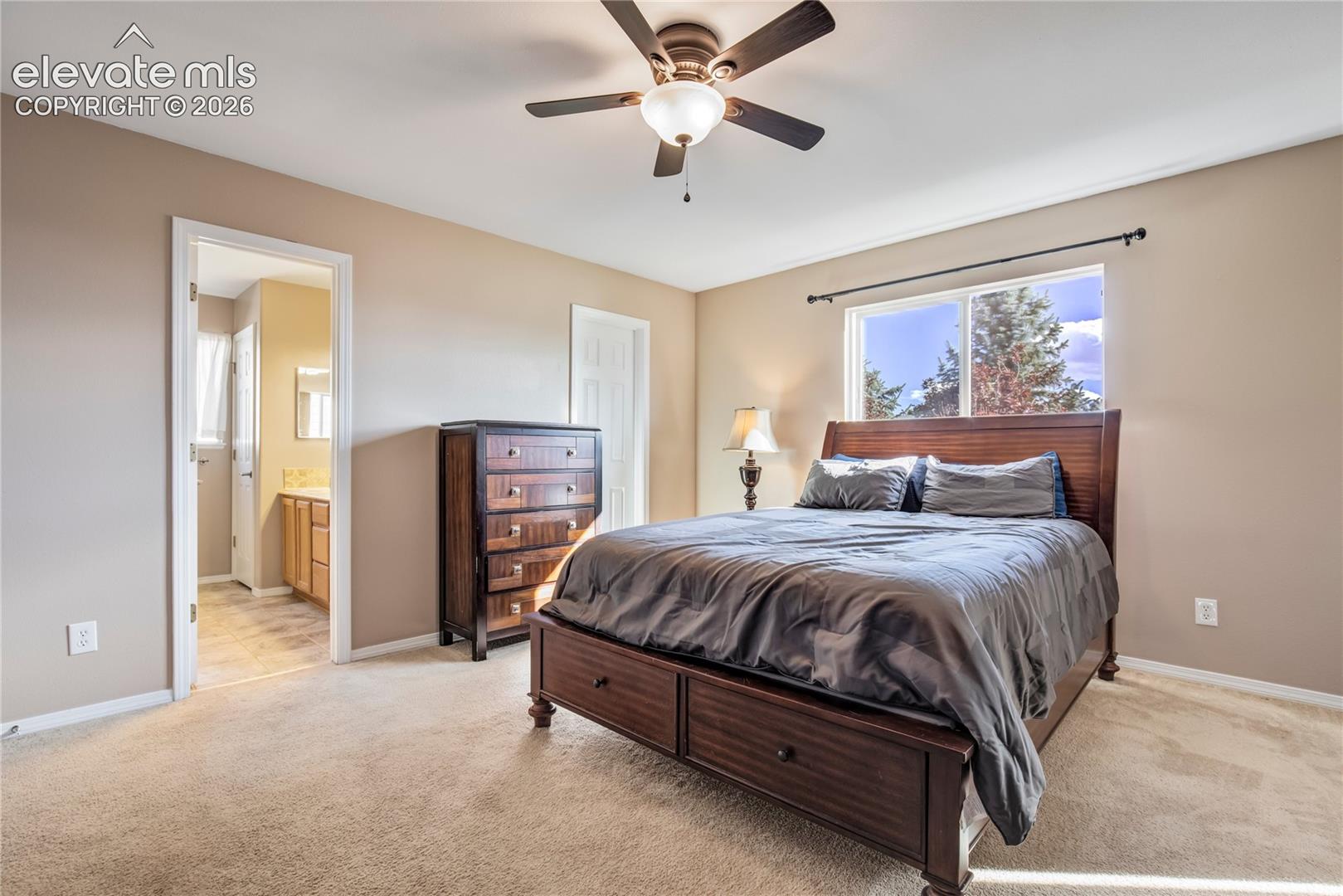 The spacious primary bedroom features a walk-in closet, adjoining 5-piece bath + private sitting room/office with a second gas fireplace, creating a comfortable upper-level retreat.