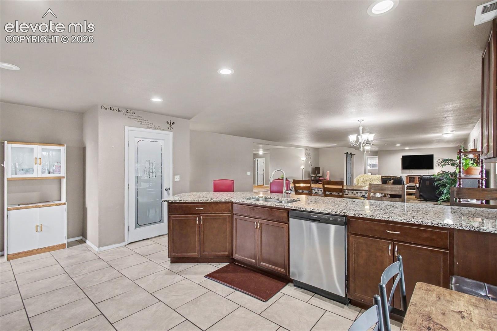 Large glass-door pantry offers abundant storage with a stylish display.