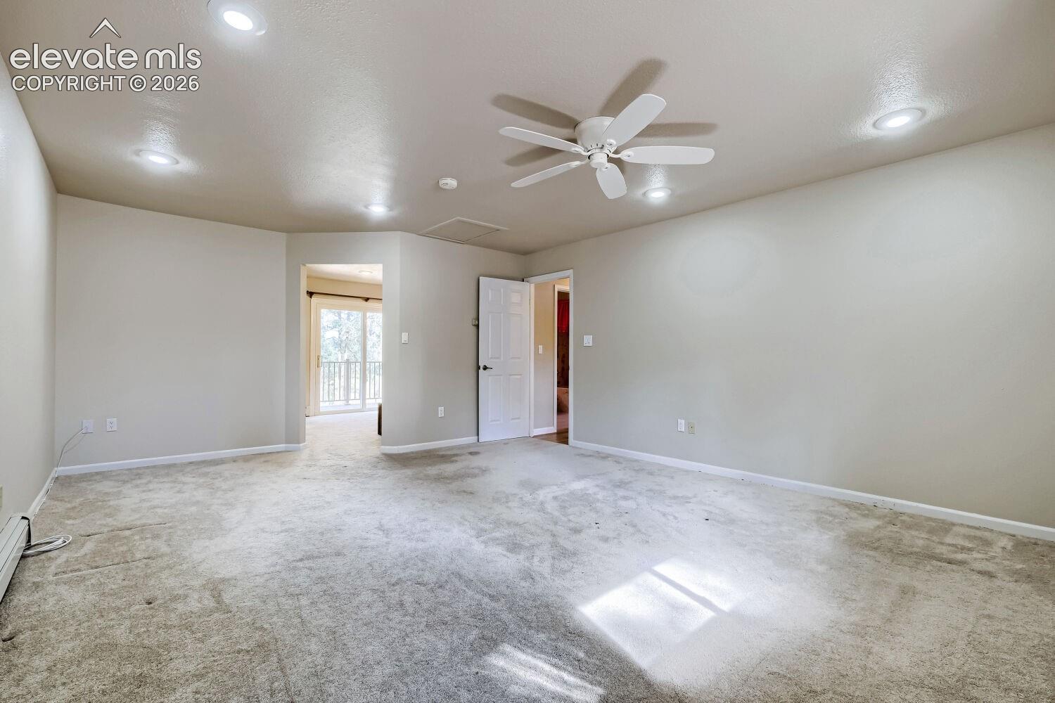 Recessed lighting, ceiling fan, carpeted flooring, and a white paneled door