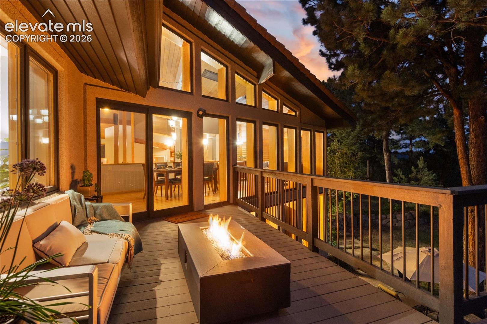 Expansive outdoor deck featuring wood-finish flooring and wood railing