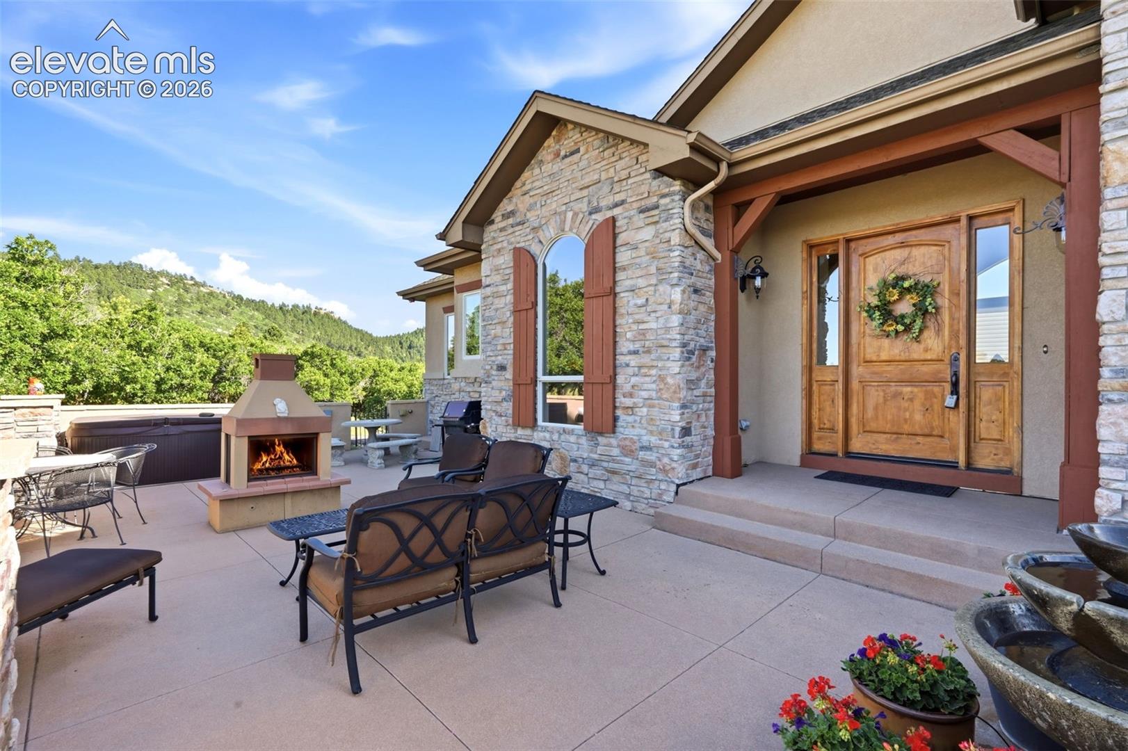Stone exterior with a wood entry door and sidelights