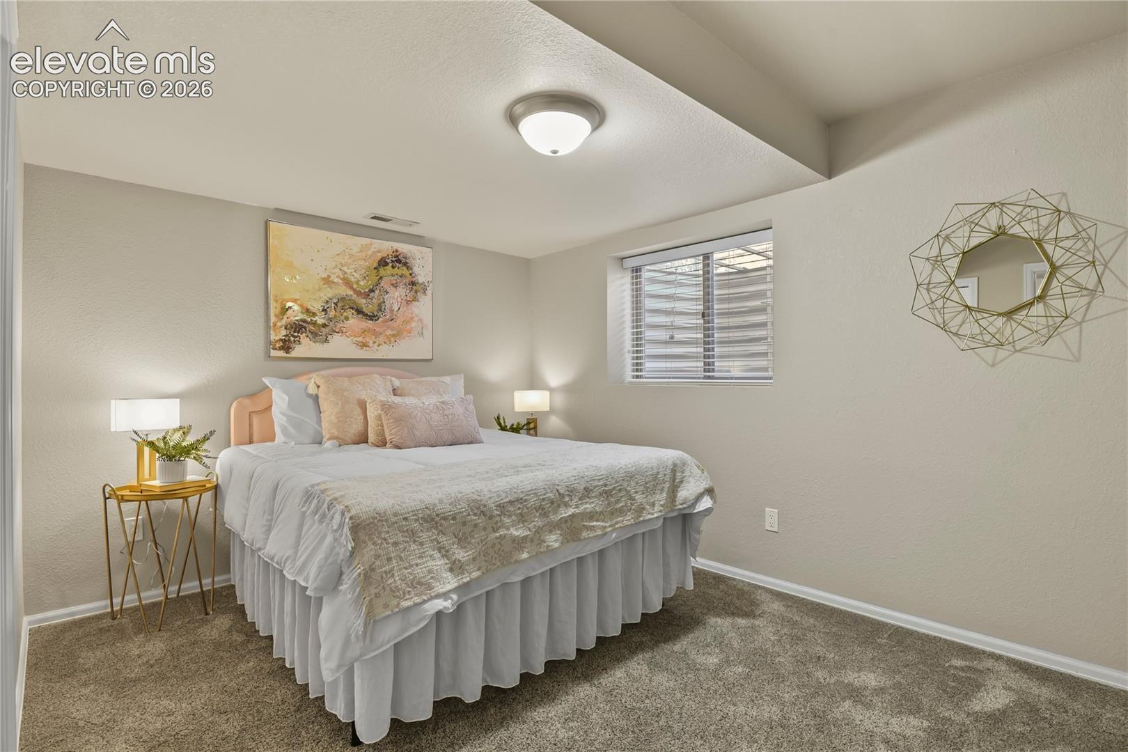 Neutral wall palette featuring carpeted flooring and a recessed window with horizontal blinds