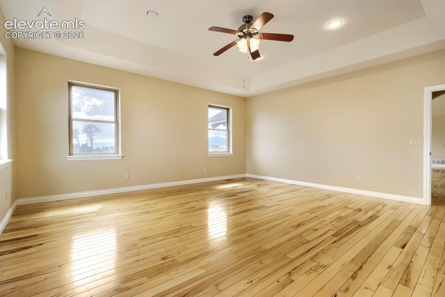These primary bedroom windows feature views of Pikes Peak. 