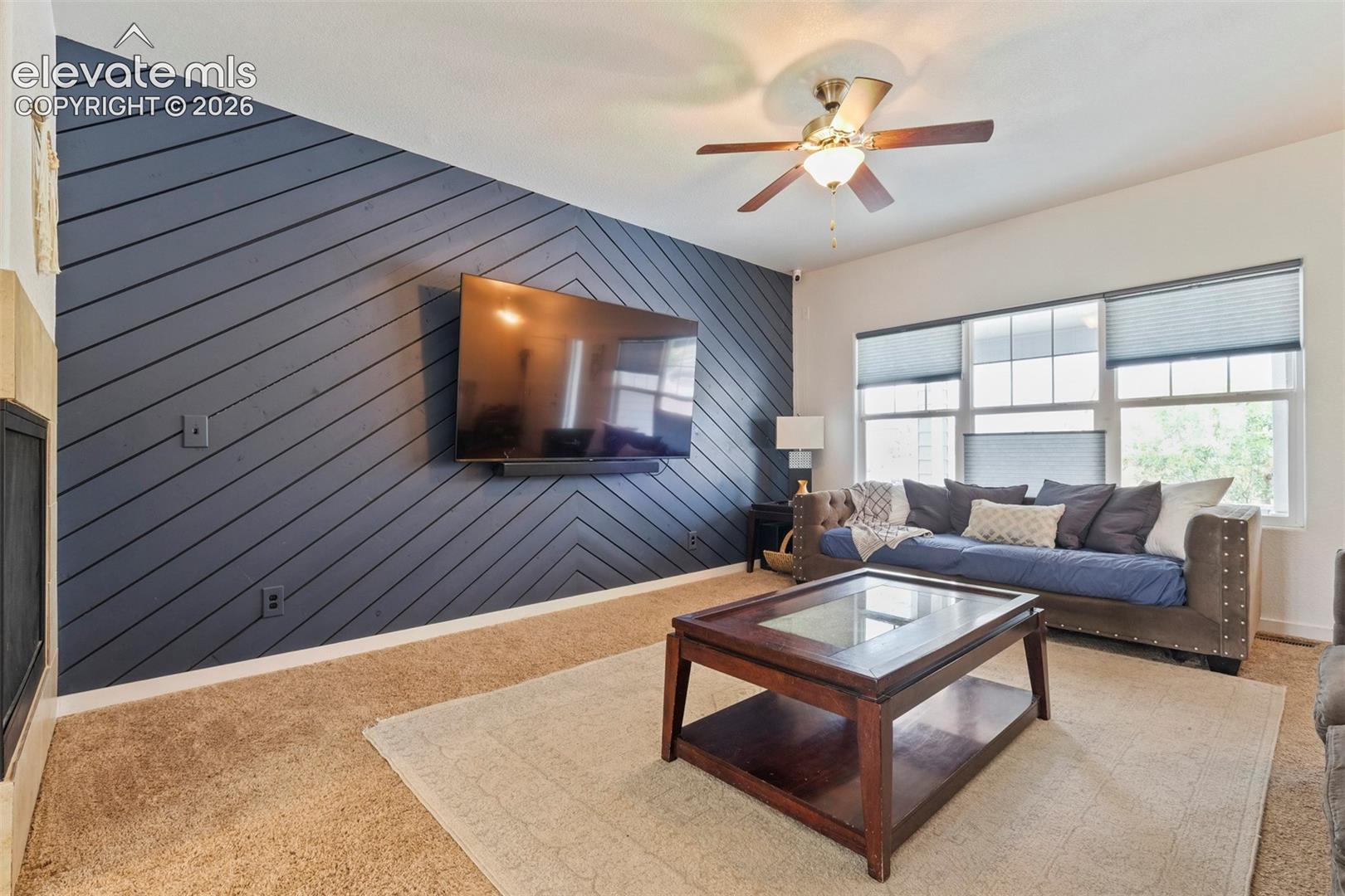 Main Level: Living space featuring a striking accent wall with a diagonal wood panel design