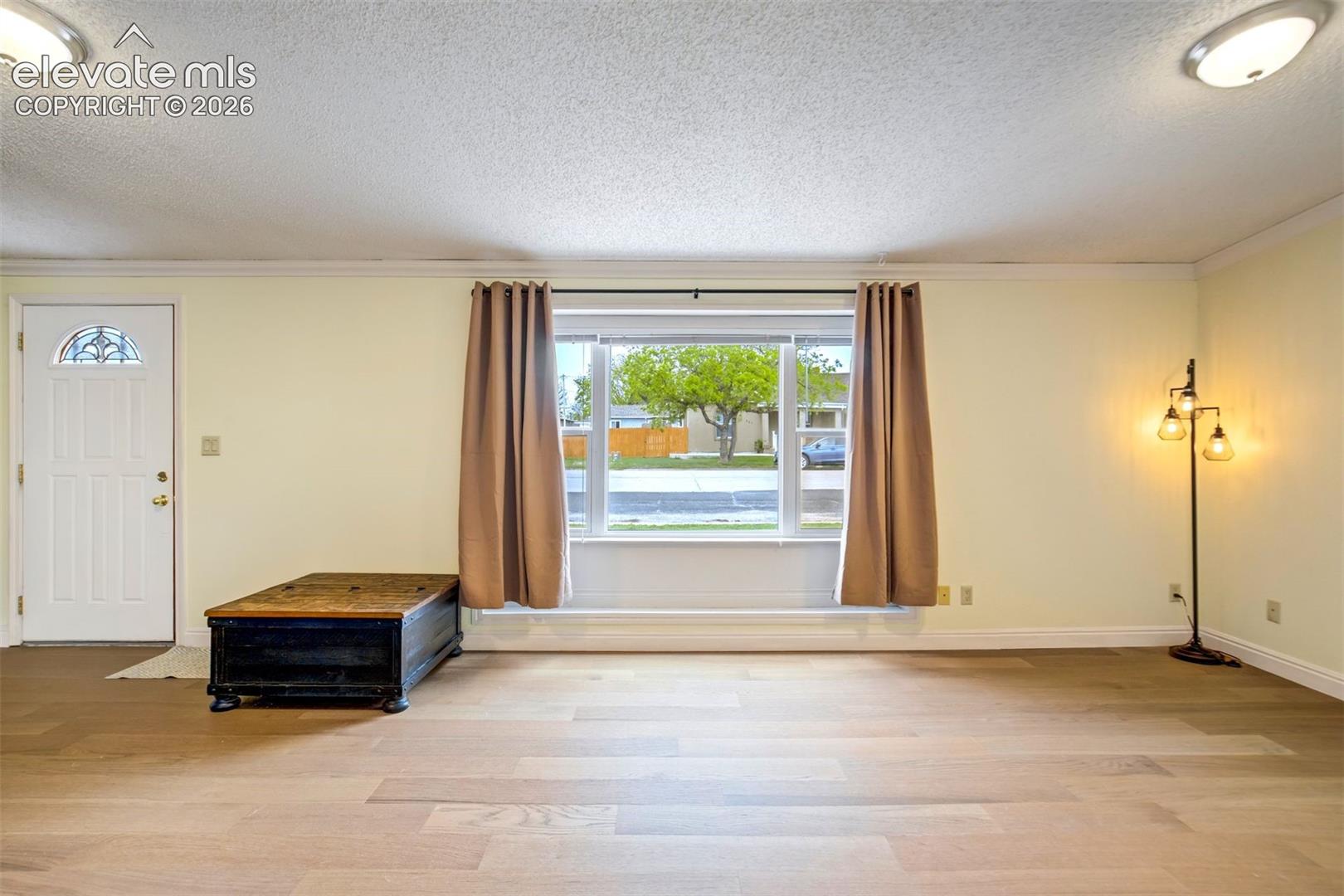 Front living room with natural light, neutral tones, and an open layout.