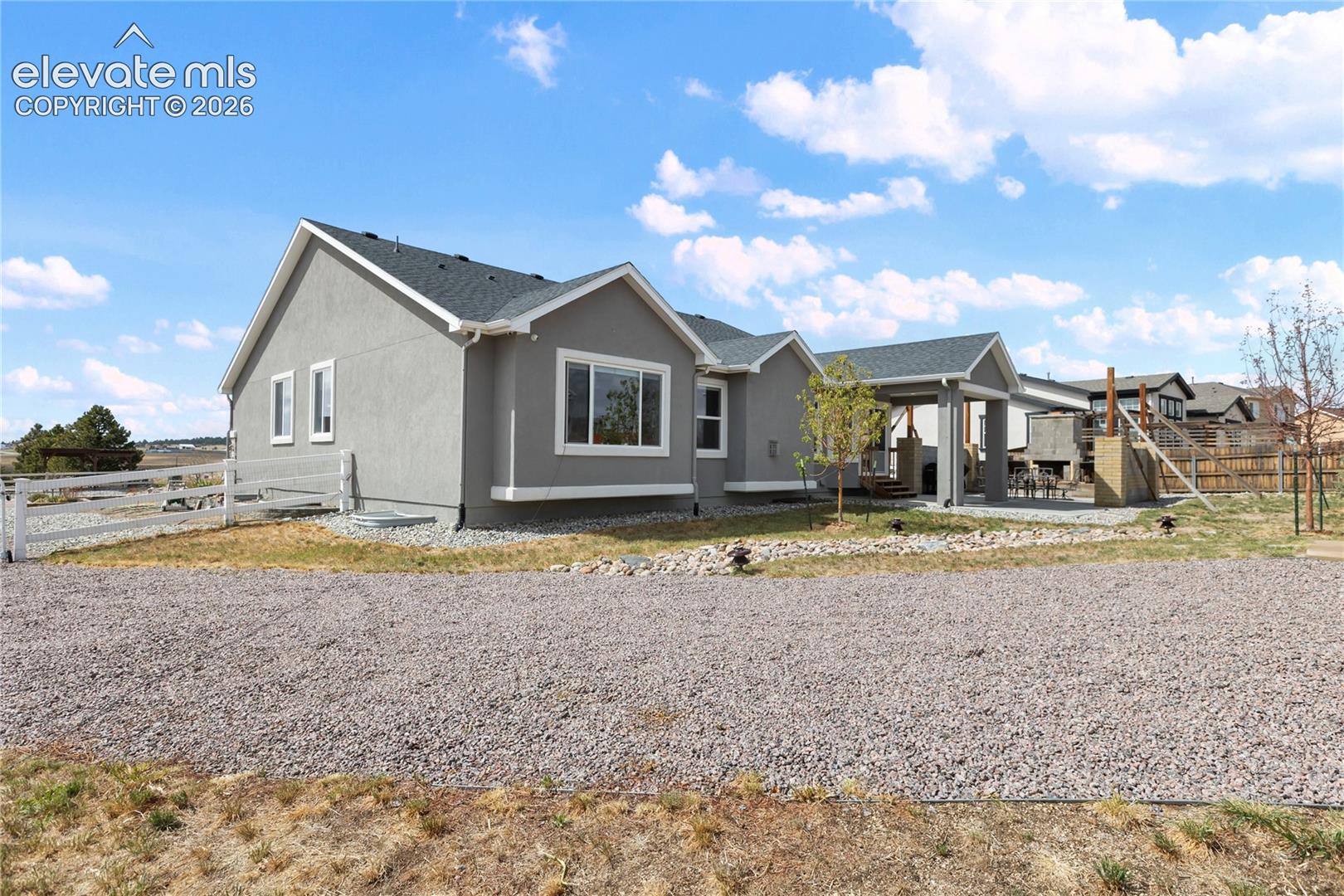 Rear exterior showcasing a covered patio with concrete flooring