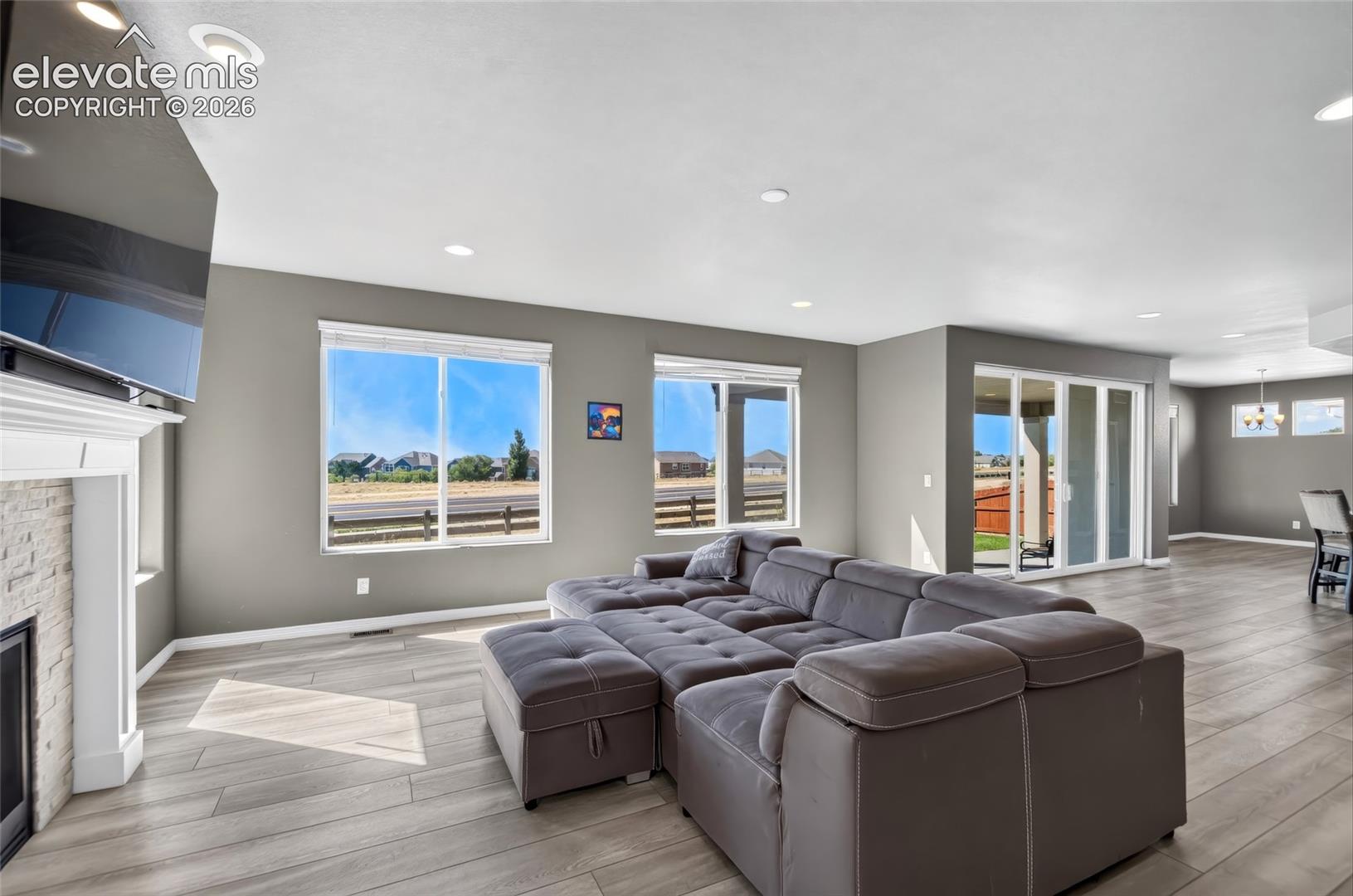 Spacious interior with neutral wall tones, recessed lighting, and wood-finish flooring