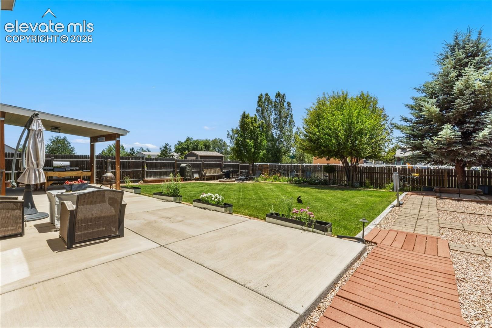 Expansive Patio & Lawn with Plenty of Space to Gather and Play
