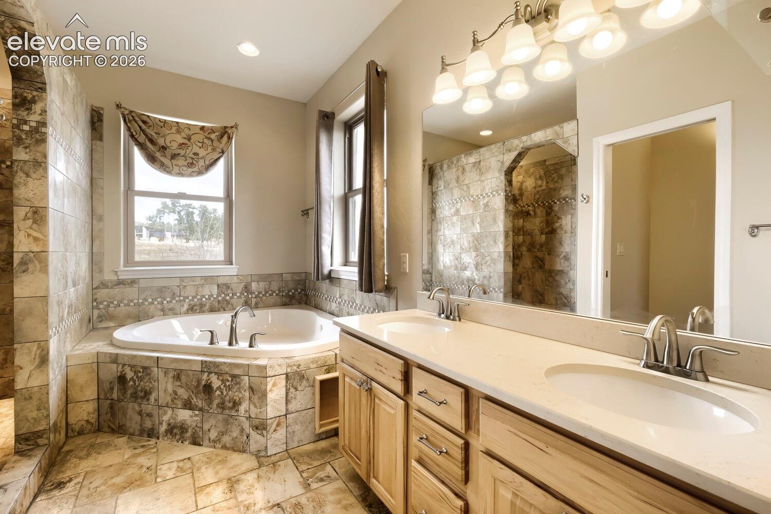 This primary bathroom features a extra large step in shower to the left of the window in this image!  