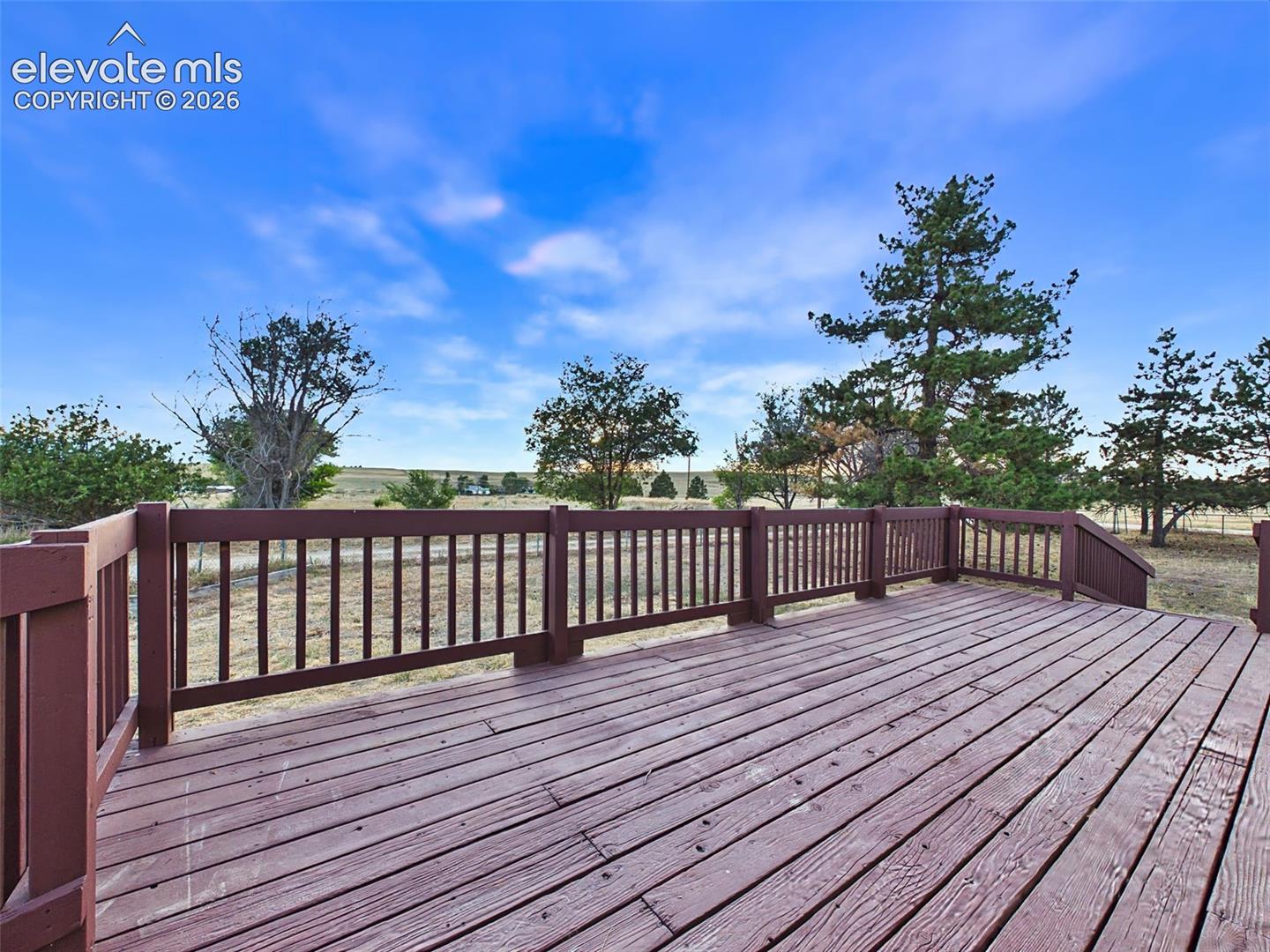Front exterior showcases the home's updated exterior, deck access, and scenic rural surroundings.