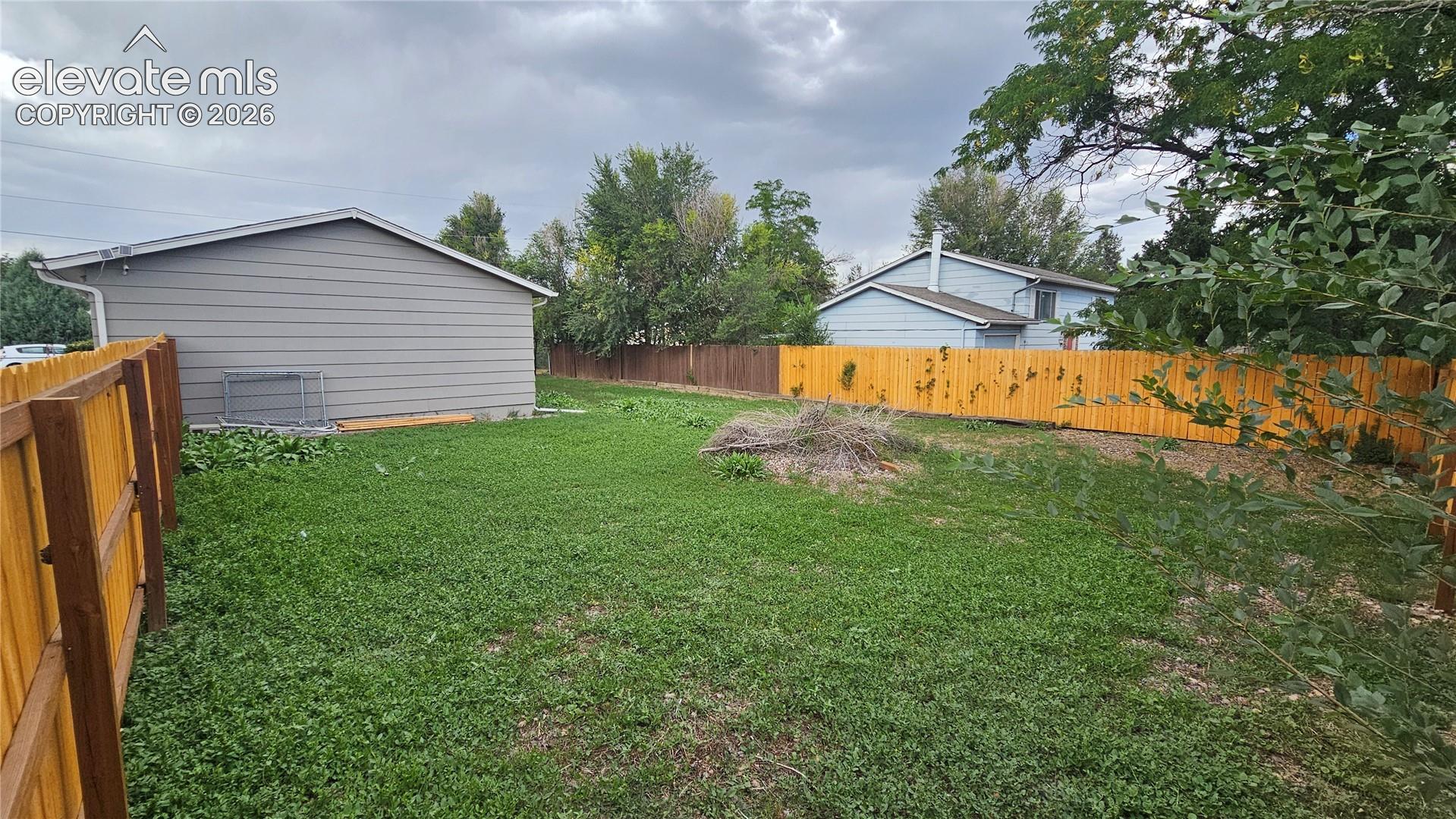 Expansive backyard featuring a wood privacy fence