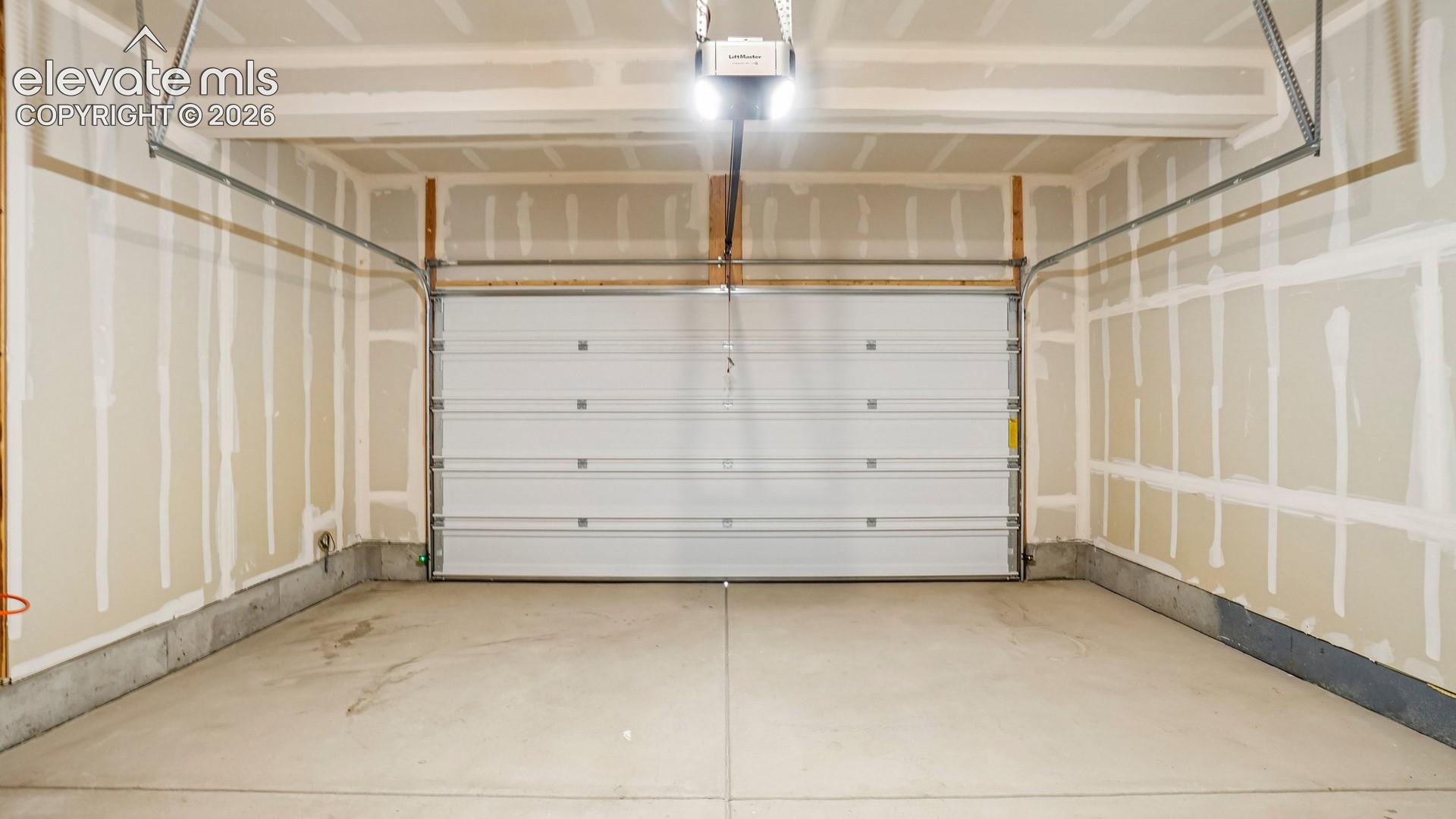 Concrete flooring, unfinished drywall, overhead lighting, garage door opener, segment panel garage door
*photos of a model home*