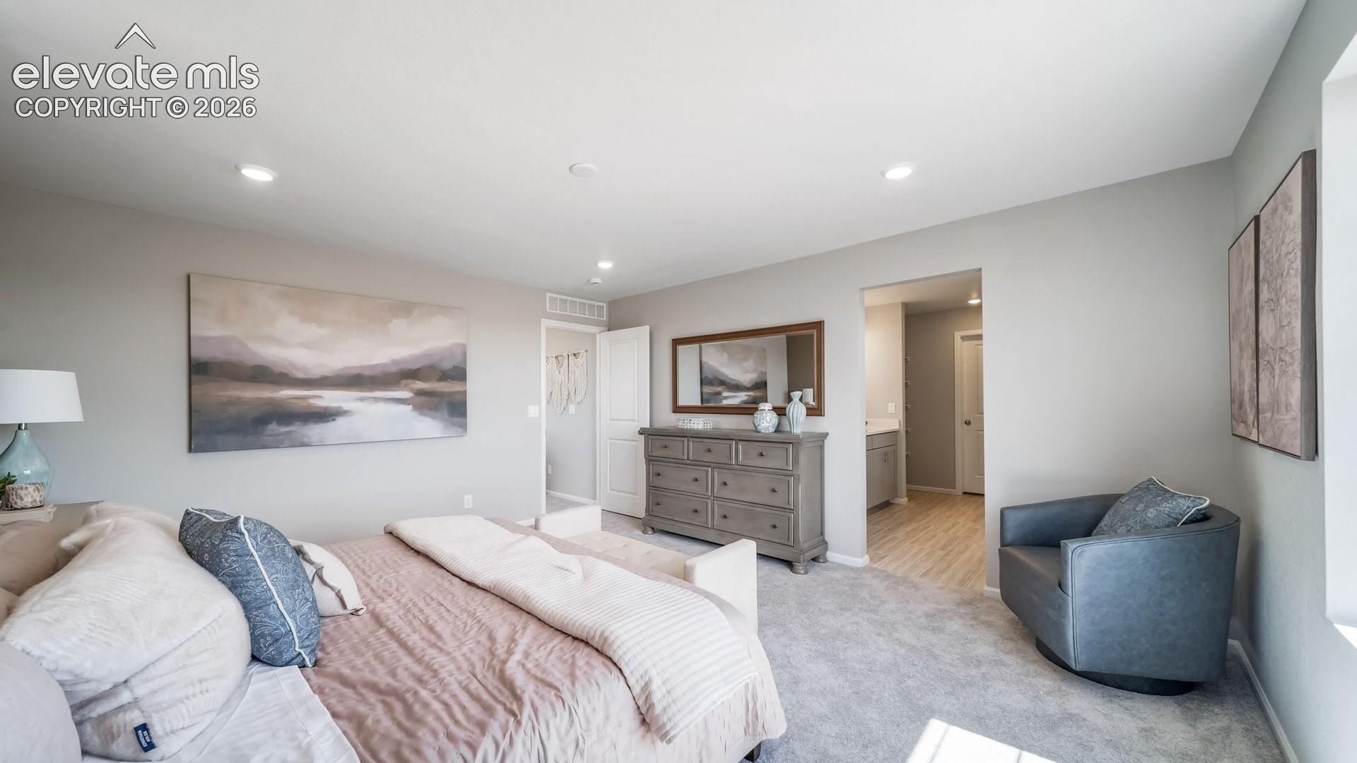 Recessed lighting, light gray wall paint, carpeting, doorway, and wood-finish flooring
*photos of a model home*