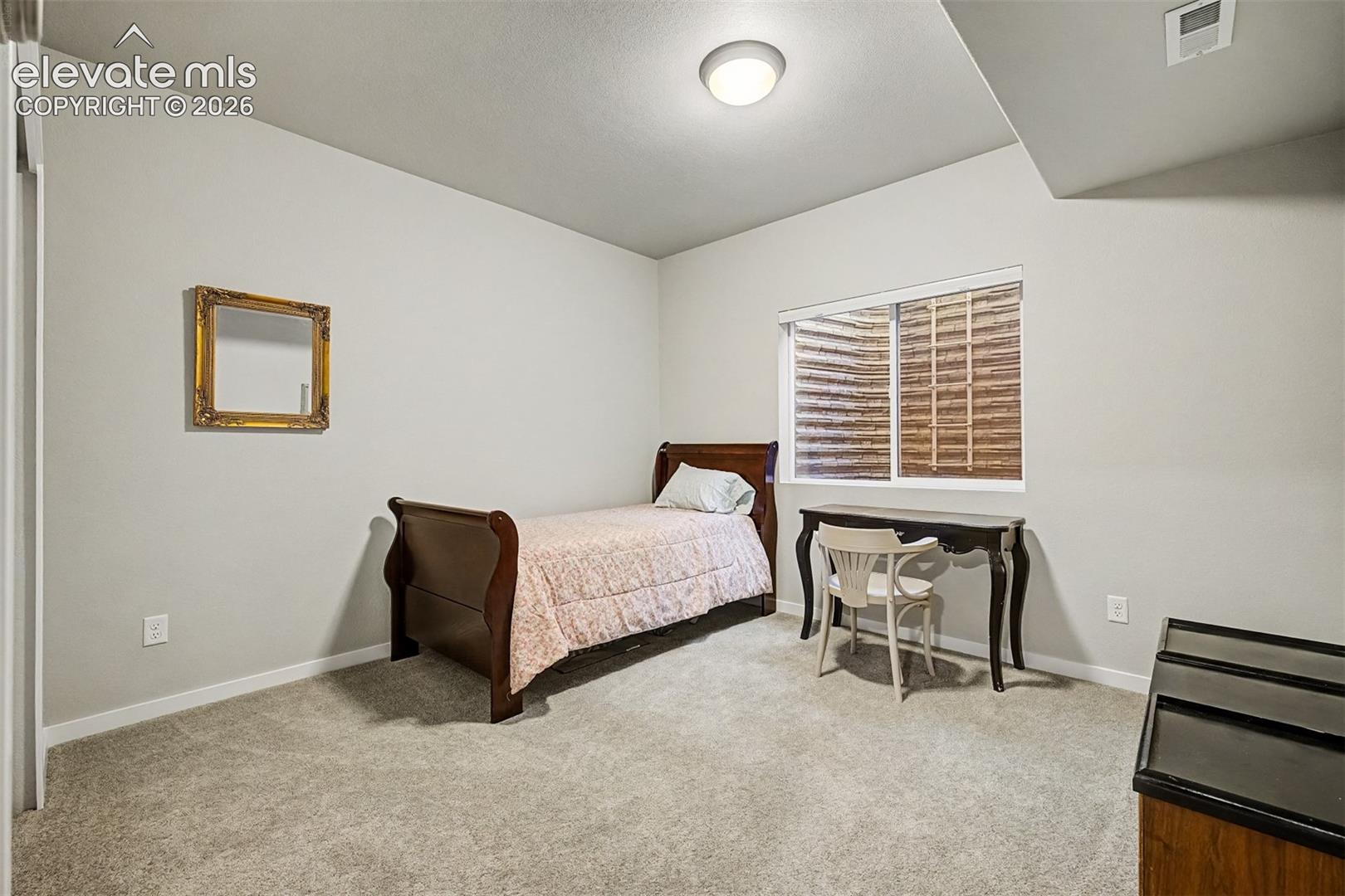 One of two lower-level bedrooms connected by a Jack-and-Jill bath, offering privacy and a thoughtful layout for additional household members or guests.