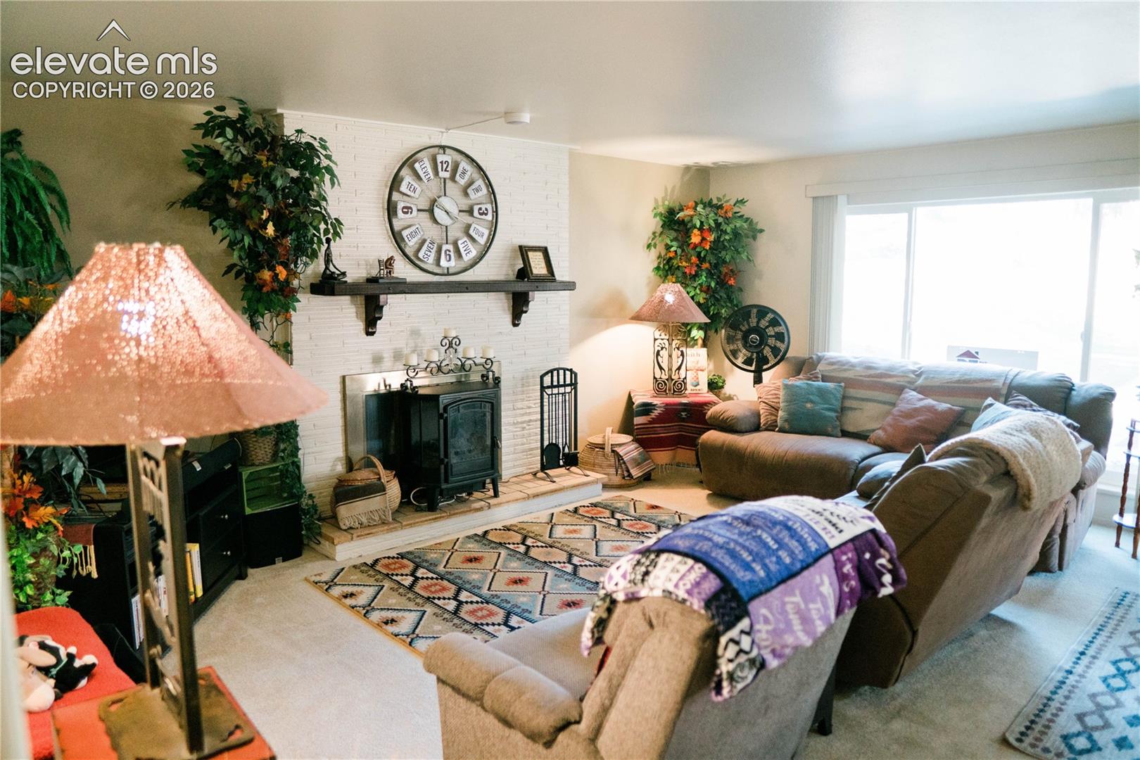 White brick fireplace with dark wood mantle